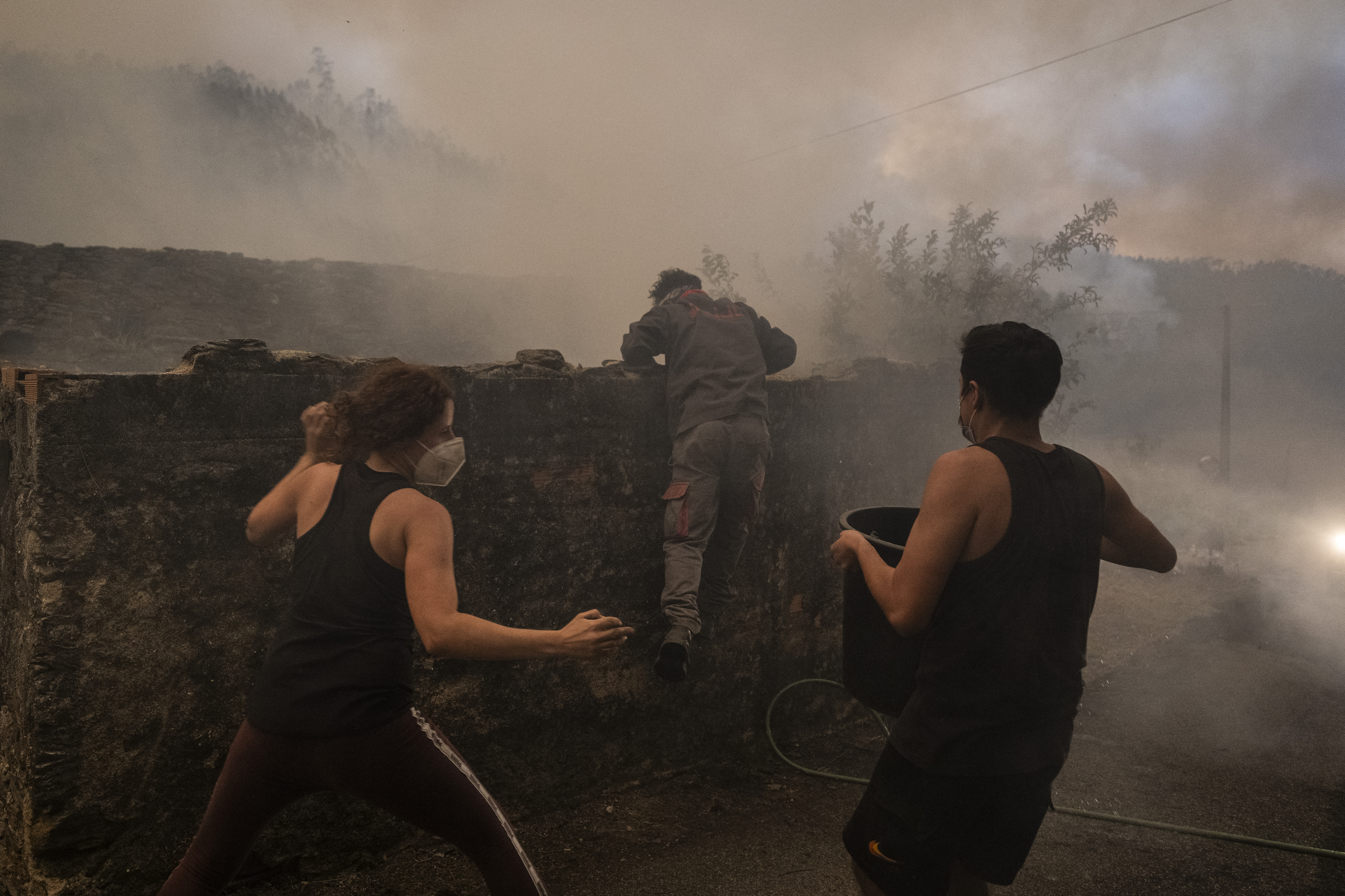 Villagers combat a wildfire in Busturenga, Albergaria-a-Velha in Aveiro on September 16, 2024