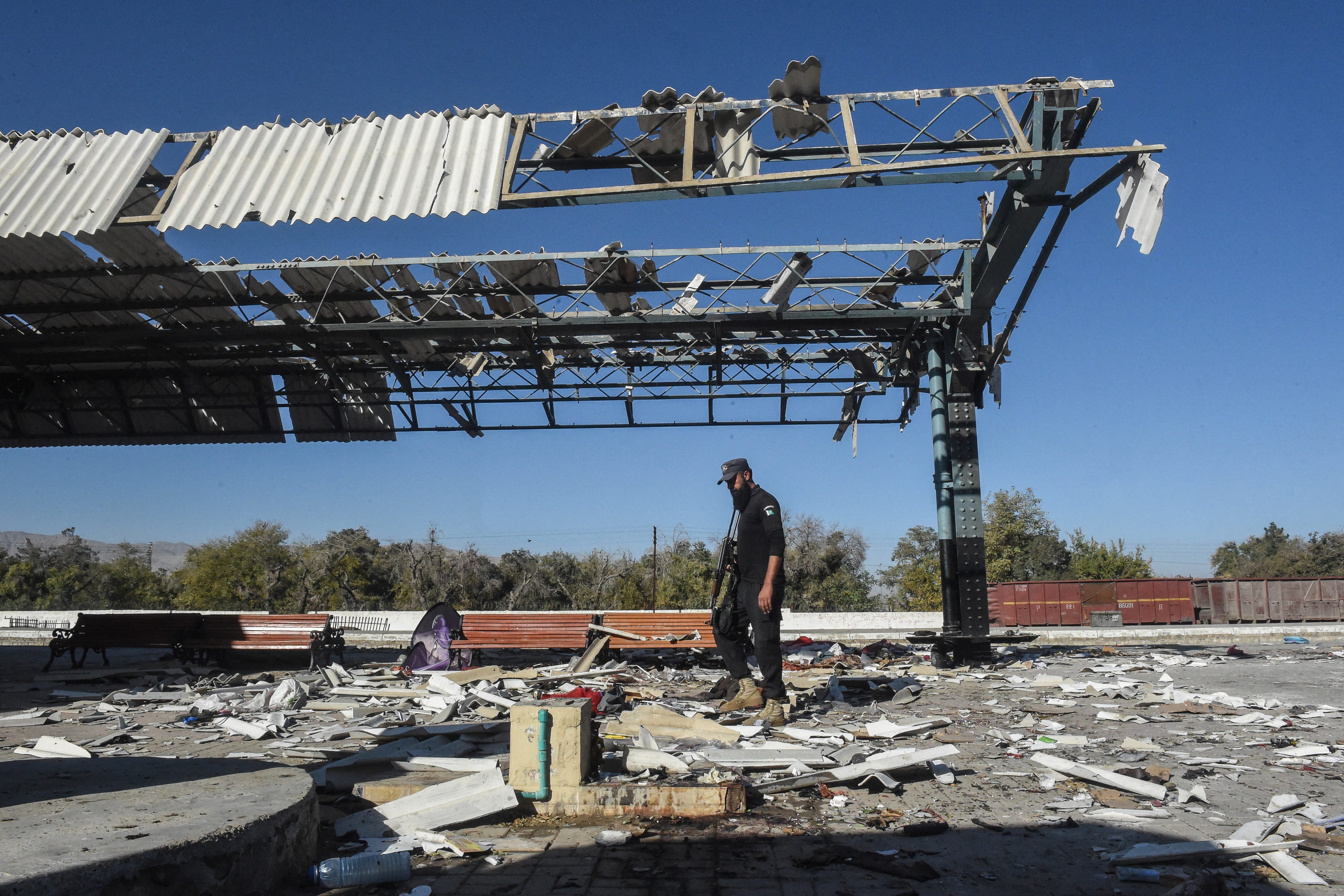 A security person inspects the blast site at a railway station in Quetta, Pakistan