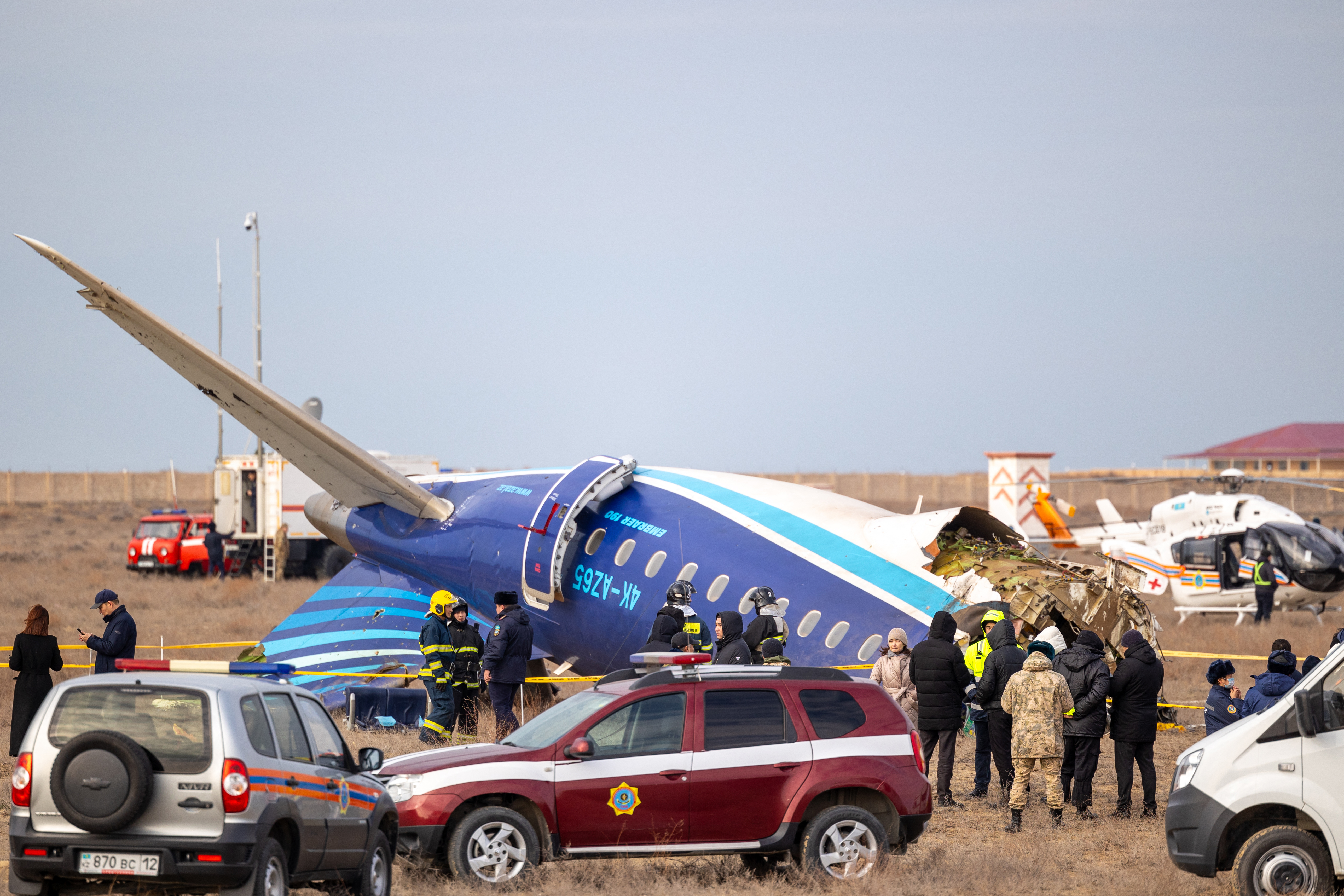 Emergency specialists work at the crash site of an Azerbaijan Airlines passenger jet near the western Kazakh city of Aktau on December 25, 2024. (Photo by Issa Tazhenbayev / AFP)