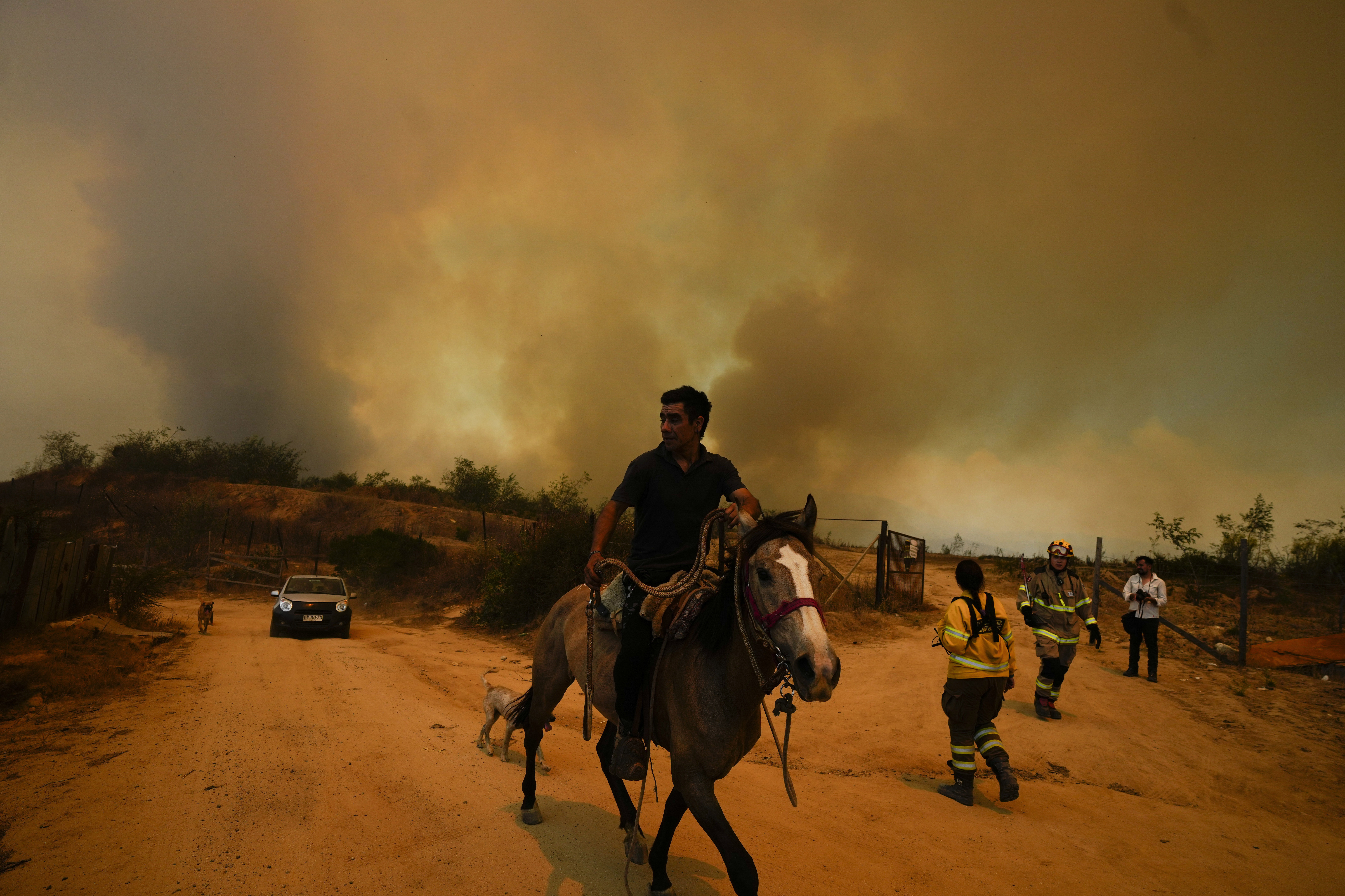 A resident flees an encroaching forest fire in Vina del Mar, Chile, Saturday, Feb. 3, 2024