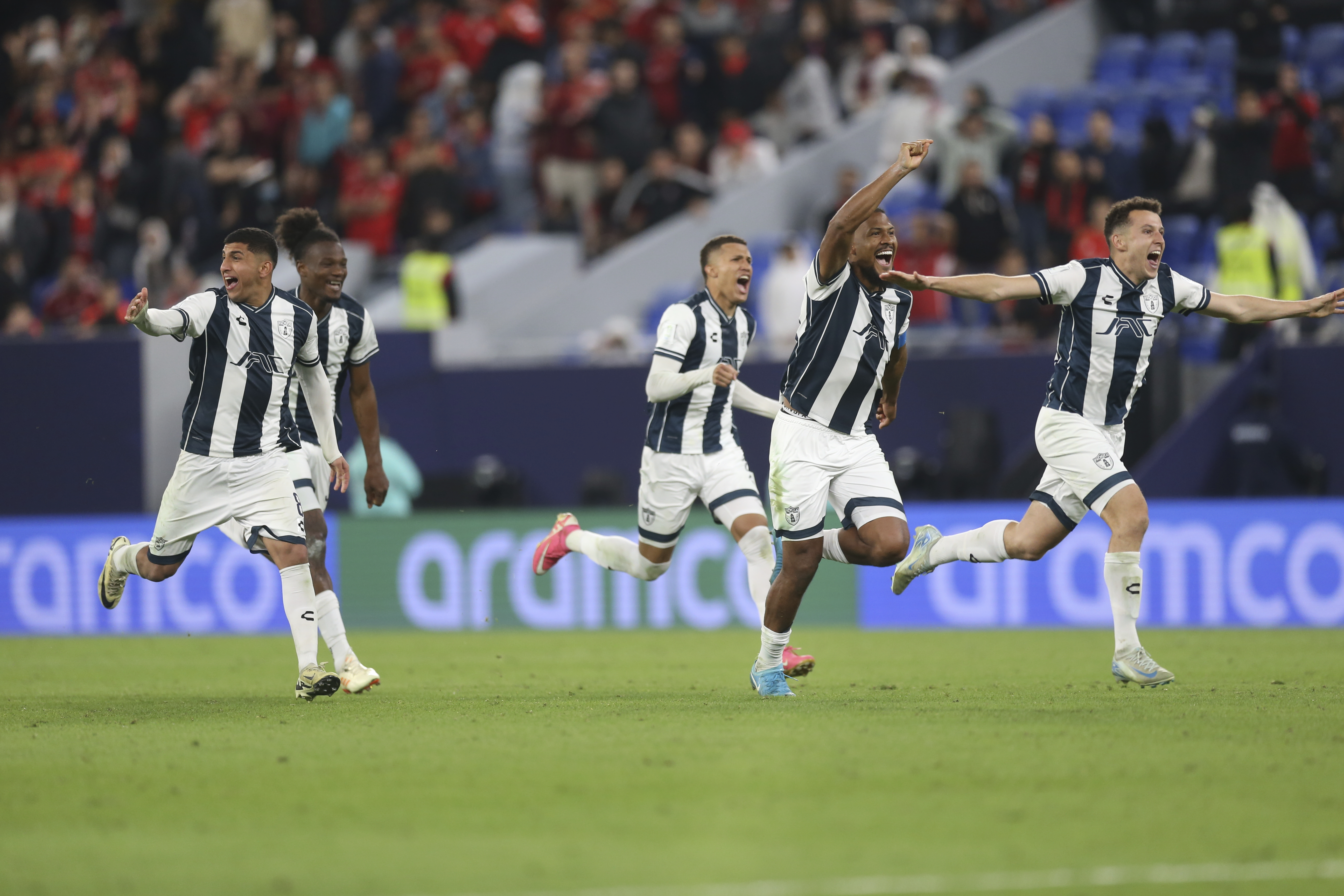 Pachuca's players celebrate after defeating Al Ahly FC in a penalty shootout during the Intercontinental Cup soccer match at Stadium 974 in Doha, Qatar, Saturday, Dec. 14, 2024. (AP Photo/Hussein Sayed)