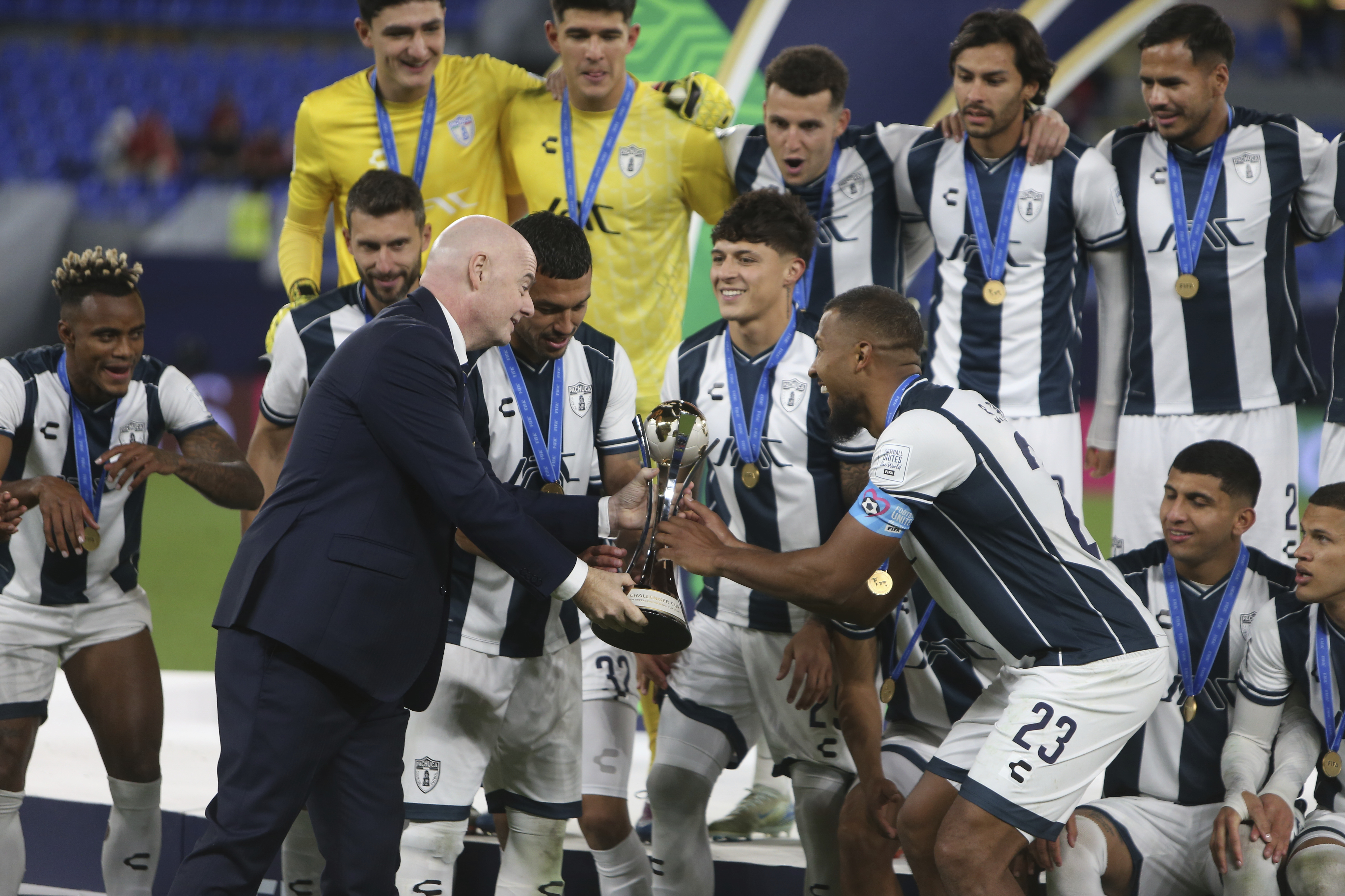 CF Pachuca's Salomon Rondon (23) receives the trophy from FIFA President Gianni Infantino after winning their Intercontinental Cup soccer match against Al Ahly FC at Stadium 974 in Doha, Qatar, Saturday, Dec. 14, 2024. (AP Photo/Hussein Sayed)