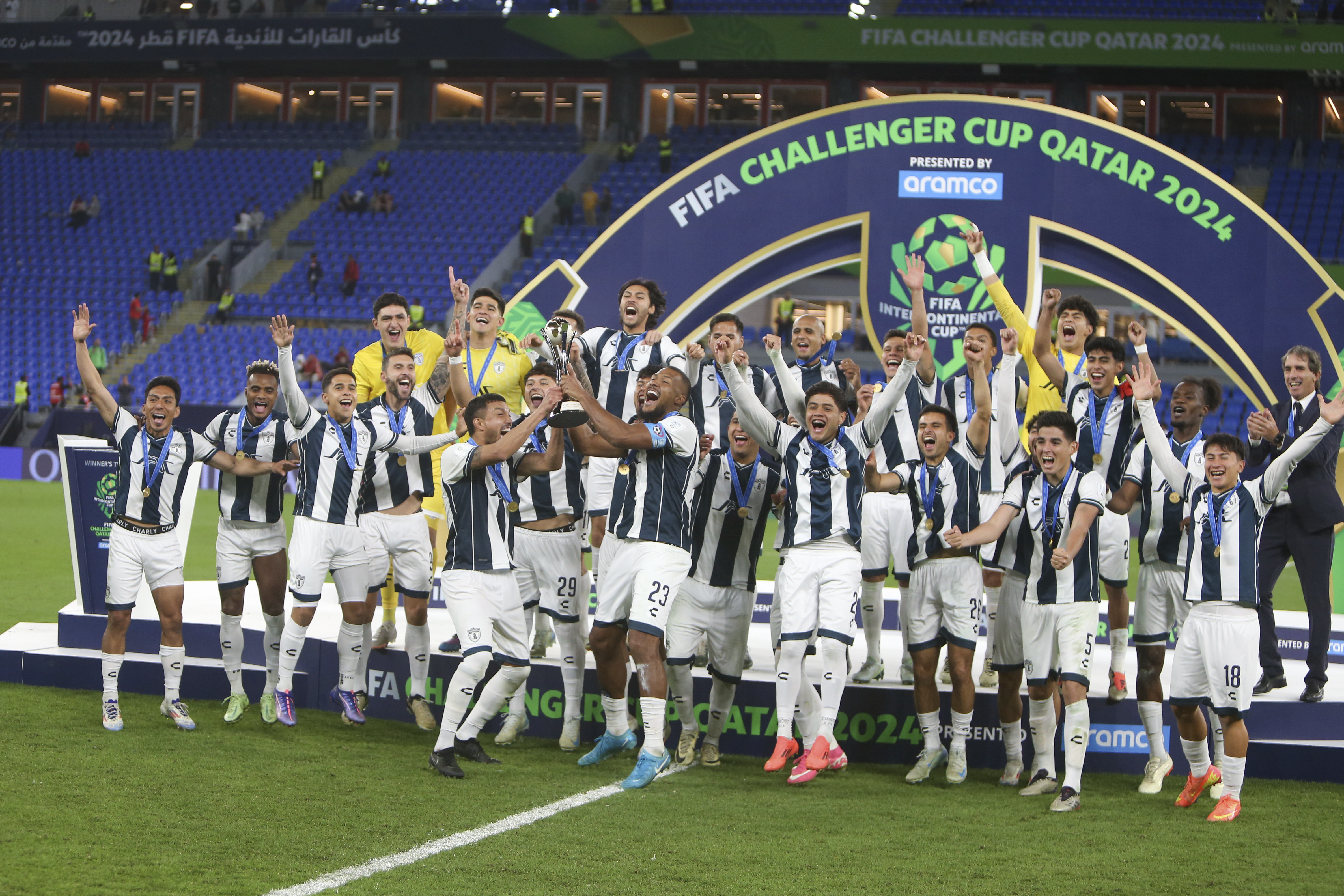 CF Pachuca players celebrate with the trophy after winning their Intercontinental Cup soccer match against Al Ahly FC at Stadium 974 in Doha, Qatar, Saturday, Dec. 14, 2024. (AP Photo/Hussein Sayed)