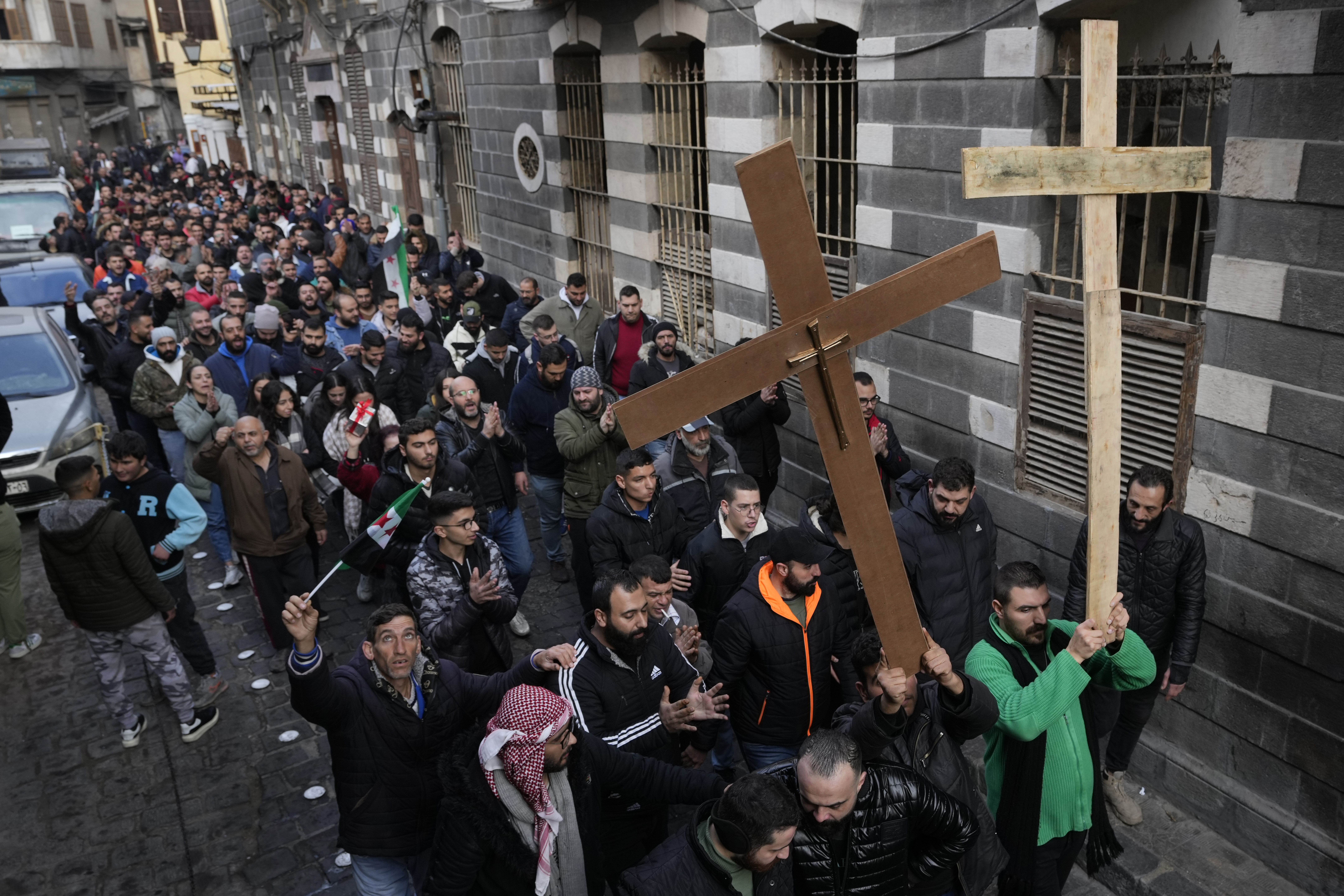 Syrian Christians carry crosses and shout slogans in Damascus