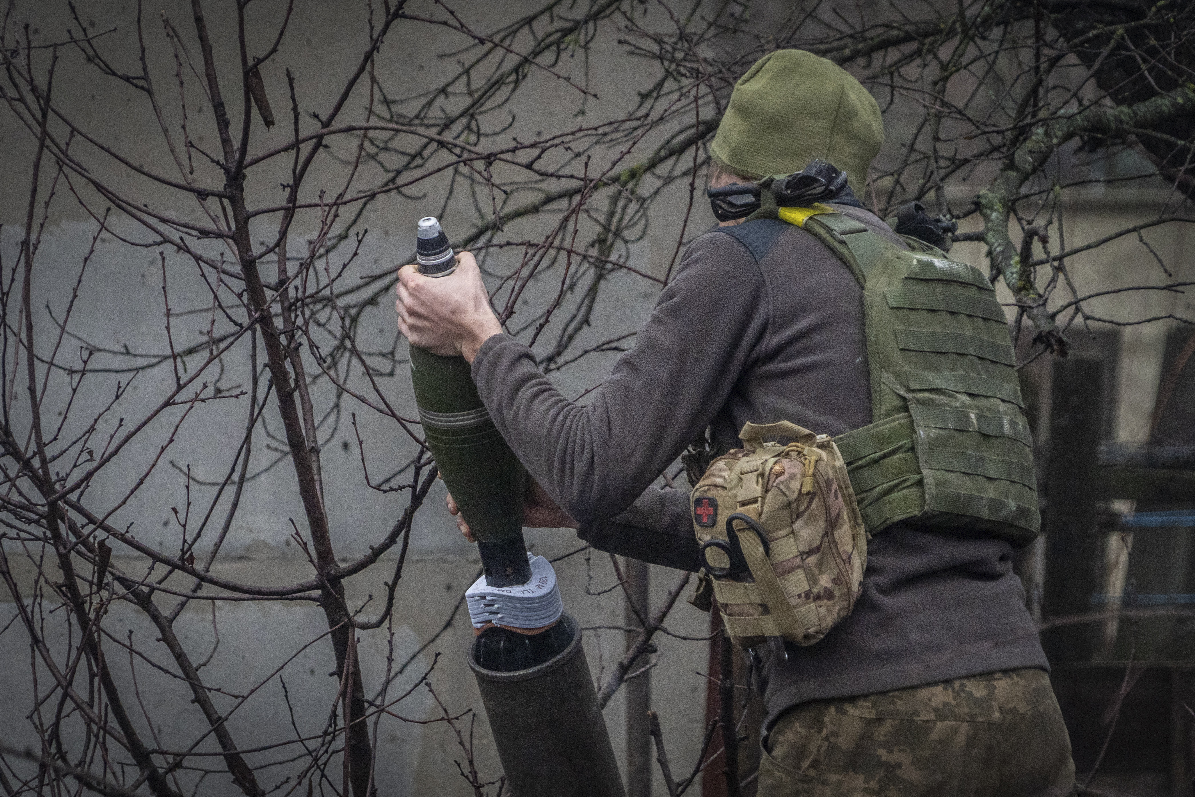 A Ukrainian serviceman of the 57th Mechanised Brigade fire 120mm mortar towards Russian positions near Kharkiv, Ukraine, Tuesday, Dec. 24, 2024. (AP Photo/Andrii Marienko)