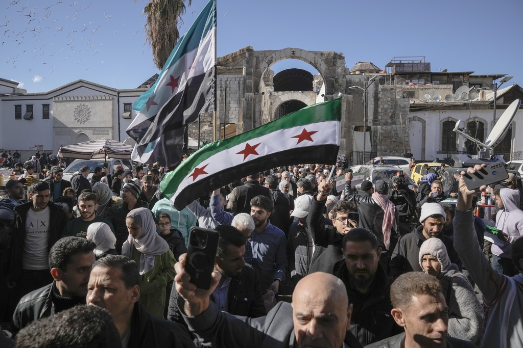 Syrians walk toward he Umayyad mosque for Friday prayers in Damascus, Syria, Friday, Dec. 13, 2024. (AP Photo/Leo Correa)