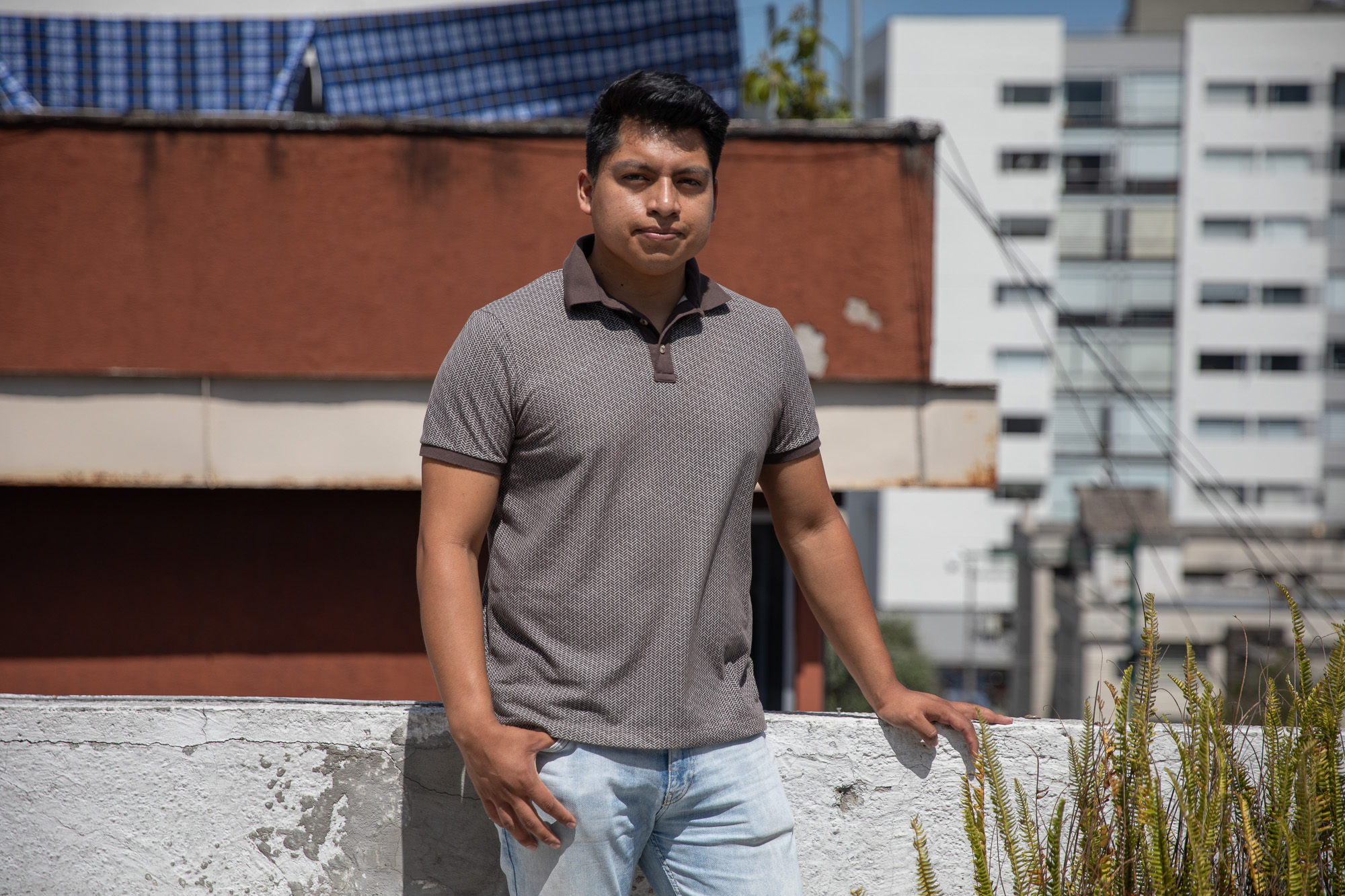 Brandon Samueza, 26, poses for a photo outdoors in Quito
