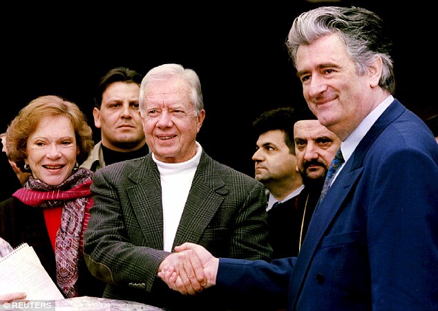 Former US President Jimmy Carter, centre, shakes hands with Radovan Karadzic, right, in Pale, Bosnia and Herzegovina, December 19, 1994 [Stringer/Files/Reuters]
