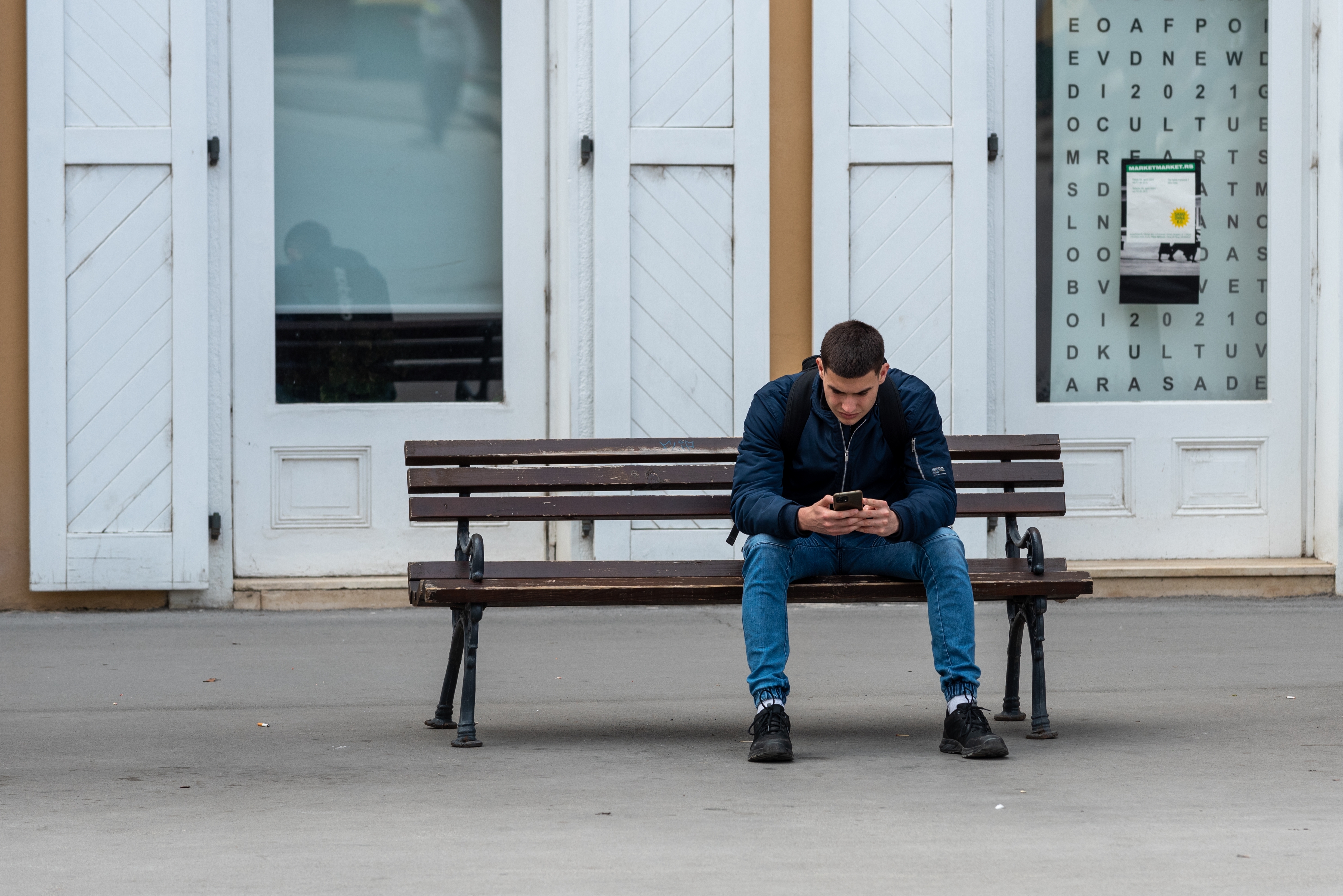 A man uses his phone in Novi Sad, Serbia on April 25, 2024 [Shutterstock]