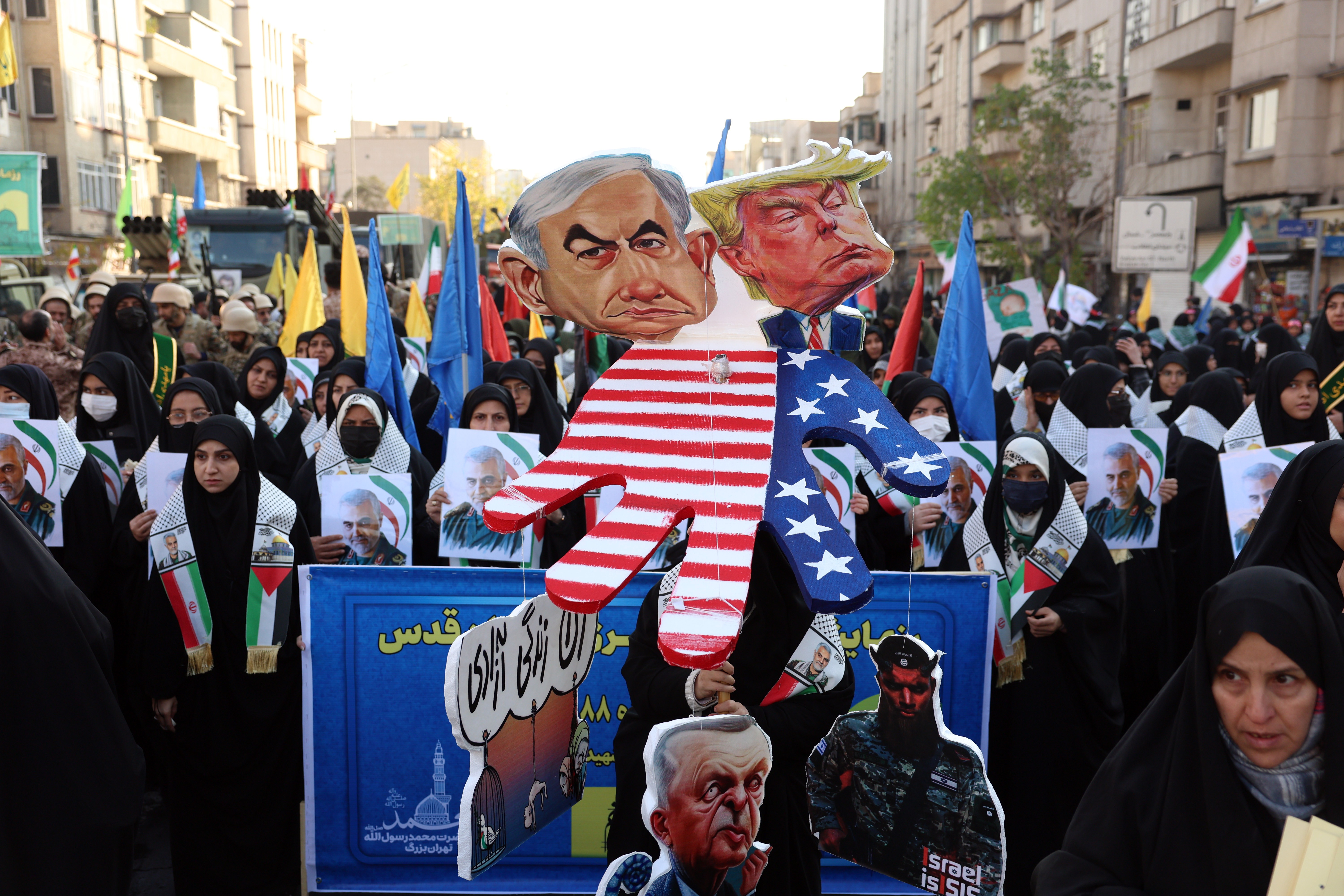 Members of Iran's female paramilitary forces (Basij) hold effigies of Israeli Prime Minister Benjamin Netanyahu and US President-elect Donald Trump as they march during an anti-Israel rally in solidarity with the Palestinian and Lebanese people in Tehran, Iran, 10 January 2025