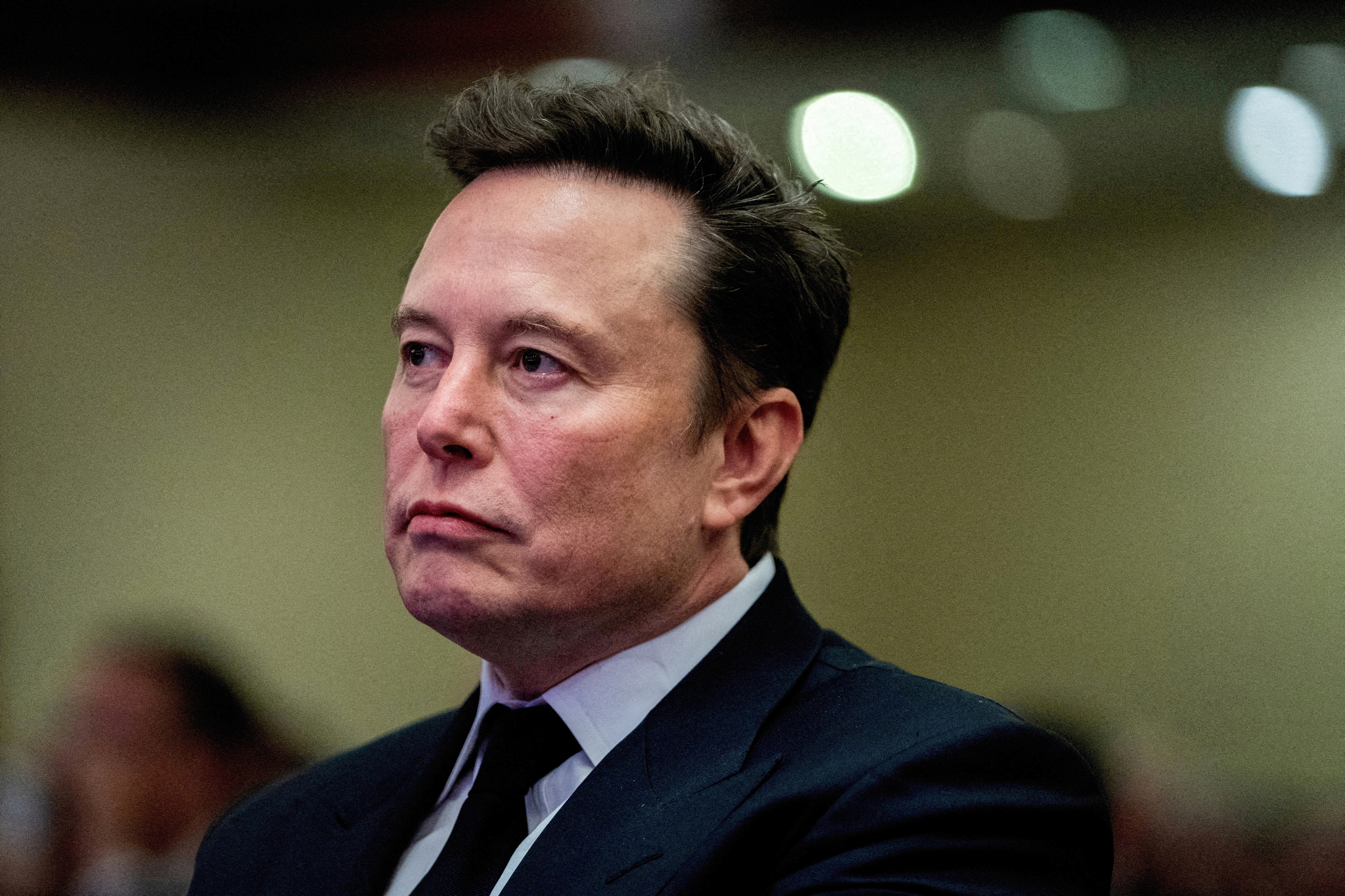 Tesla CEO and X owner Elon Musk listens as US President-elect Donald Trump speaks during a meeting with House Republicans at the Hyatt Regency hotel in Washington, DC, U.S. on November 13, 2024.