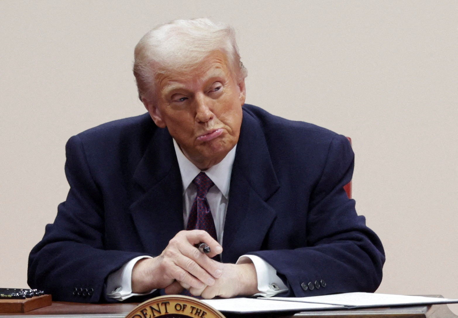 U.S. President Donald Trump reacts while signing executive orders during a rally on the inauguration day of his second Presidential term, inside Capital One, in Washington, U.S. January 20, 2025. REUTERS/Mike Segar TPX IMAGES OF THE DAY