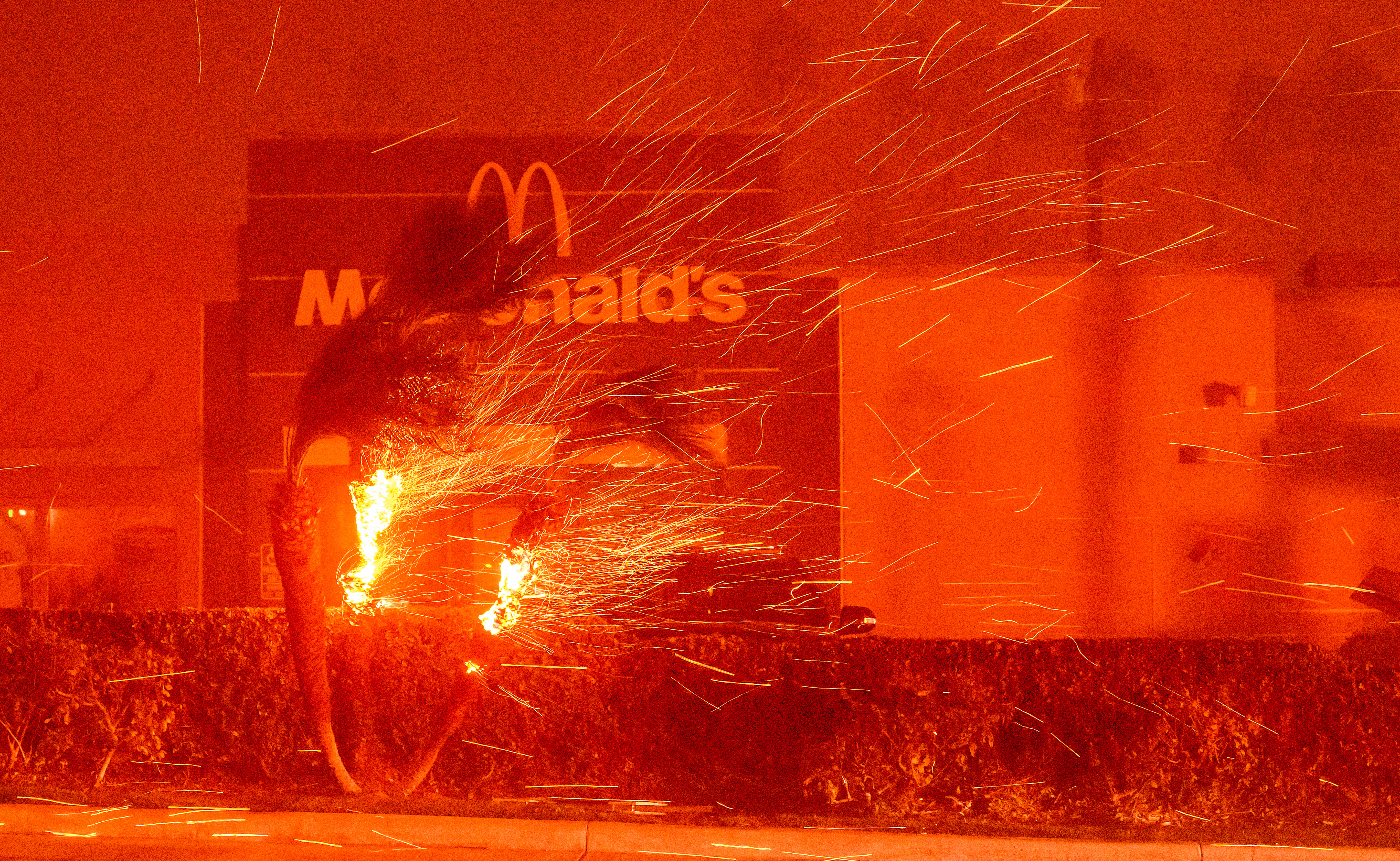 A McDonald's restaurant is showered in embers during the Eaton fire in Pasadena