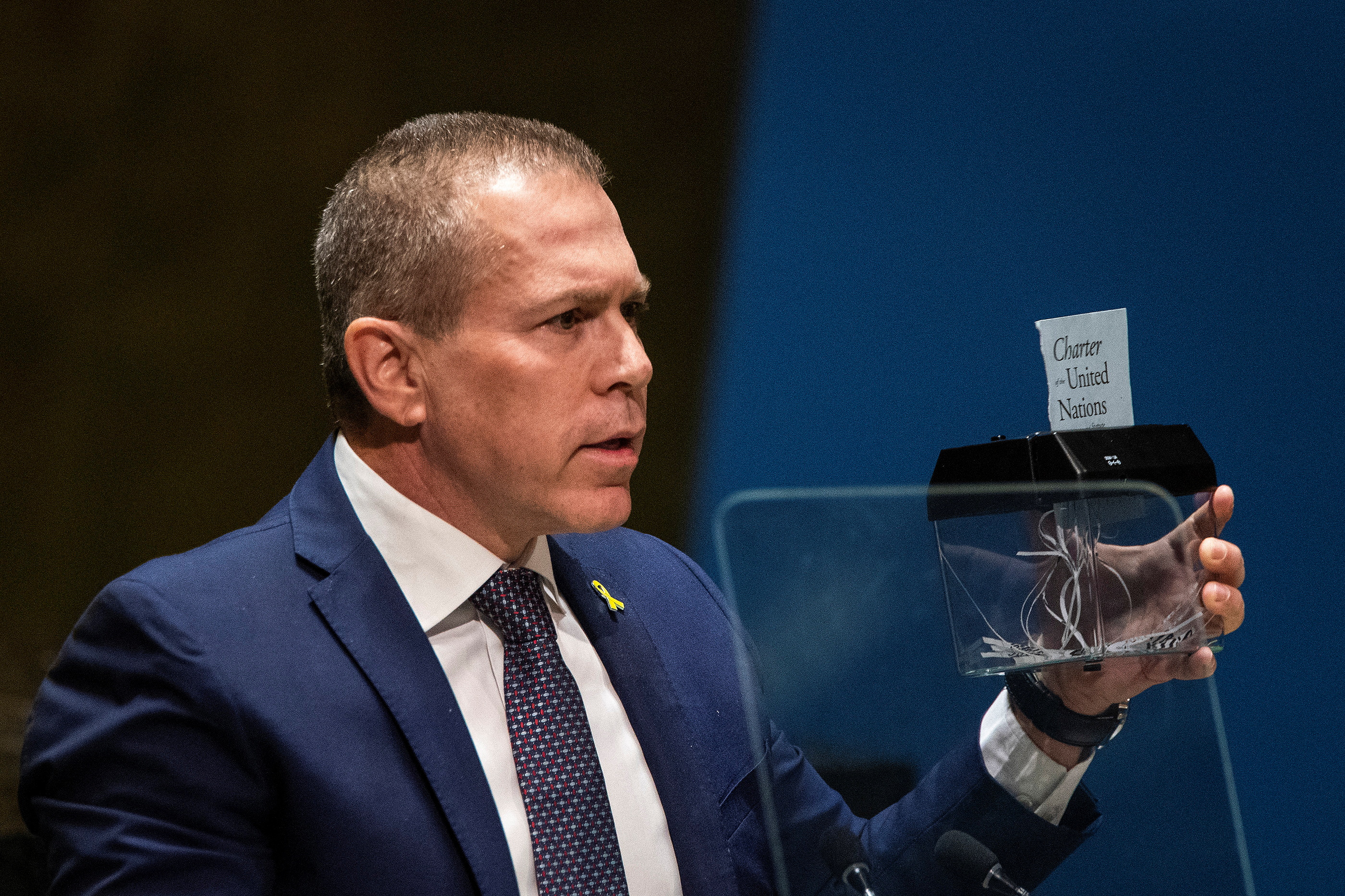 Israel's Ambassador to the United Nations Gilad Erdan destroys with a machine a piece of paper with the title of the United Nations Charter as he addresses delegates during the United Nations General Assembly before voting on a draft resolution that would recognize the Palestinians as qualified to become a full U.N. member, in New York City, U.S. May 10, 2024. REUTERS/Eduardo Munoz