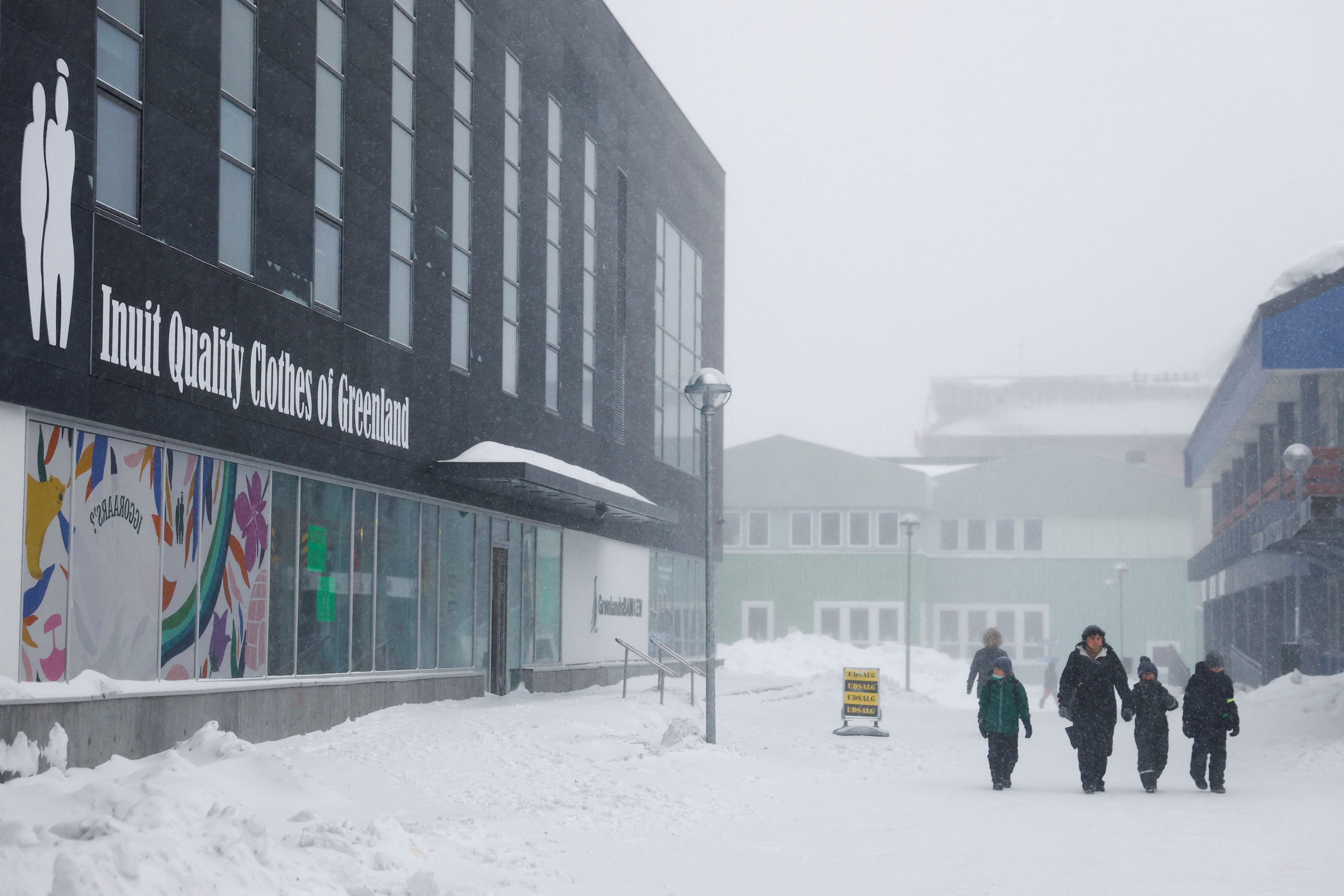 People walk near a Inuit clothing shop in Nuuk, Greenland, February 6, 2025. REUTERS/Sarah Meyssonnier