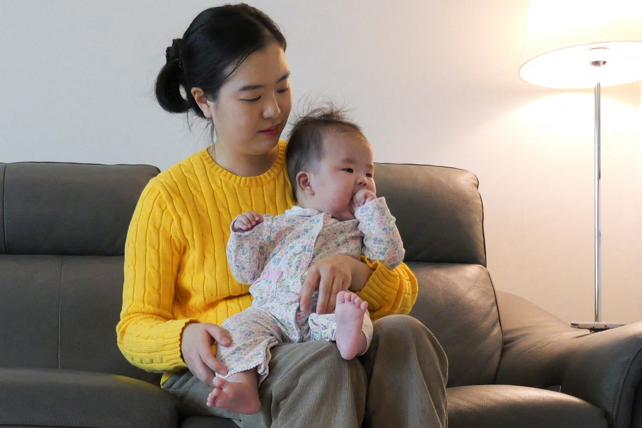 Nam Hyun-jin takes care of her baby at her home in Seoul, South Korea, February 17, 2025 [File: Daewoung Kim/Reuters]