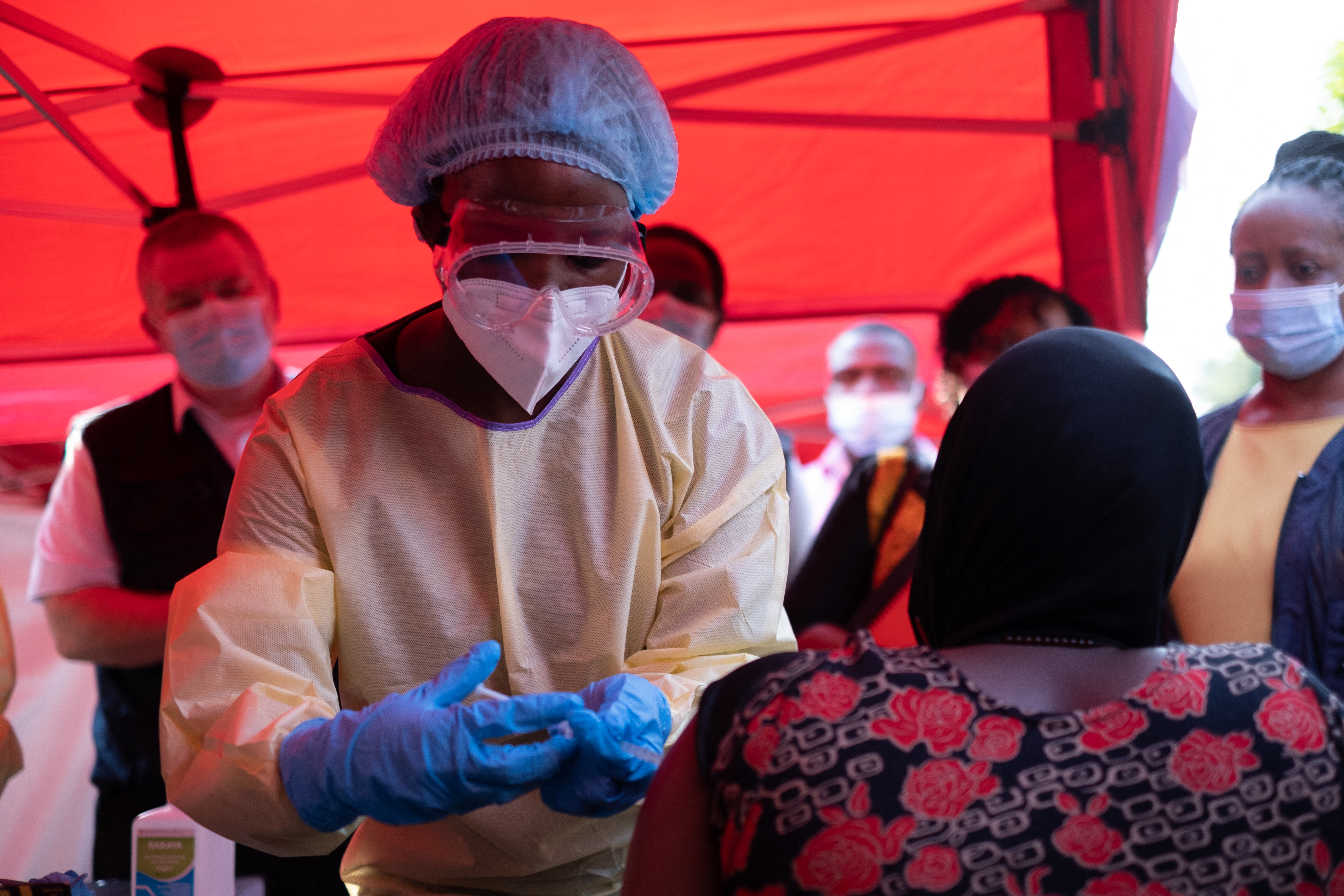 A nurse administers the first injection of the Ebola Sudan vaccine to a volunteer during the launch of an Ebola trial vaccination campaign at Mulago Referral Hospital in Kampala on February 3, 2025. Uganda started an Ebola Sudan virus vaccination trial on February 3, 2024, four days after an outbreak was confirmed, the WHO announced, beginning with those deemed at highest risk of the disease. (Photo by Badru Katumba / AFP)