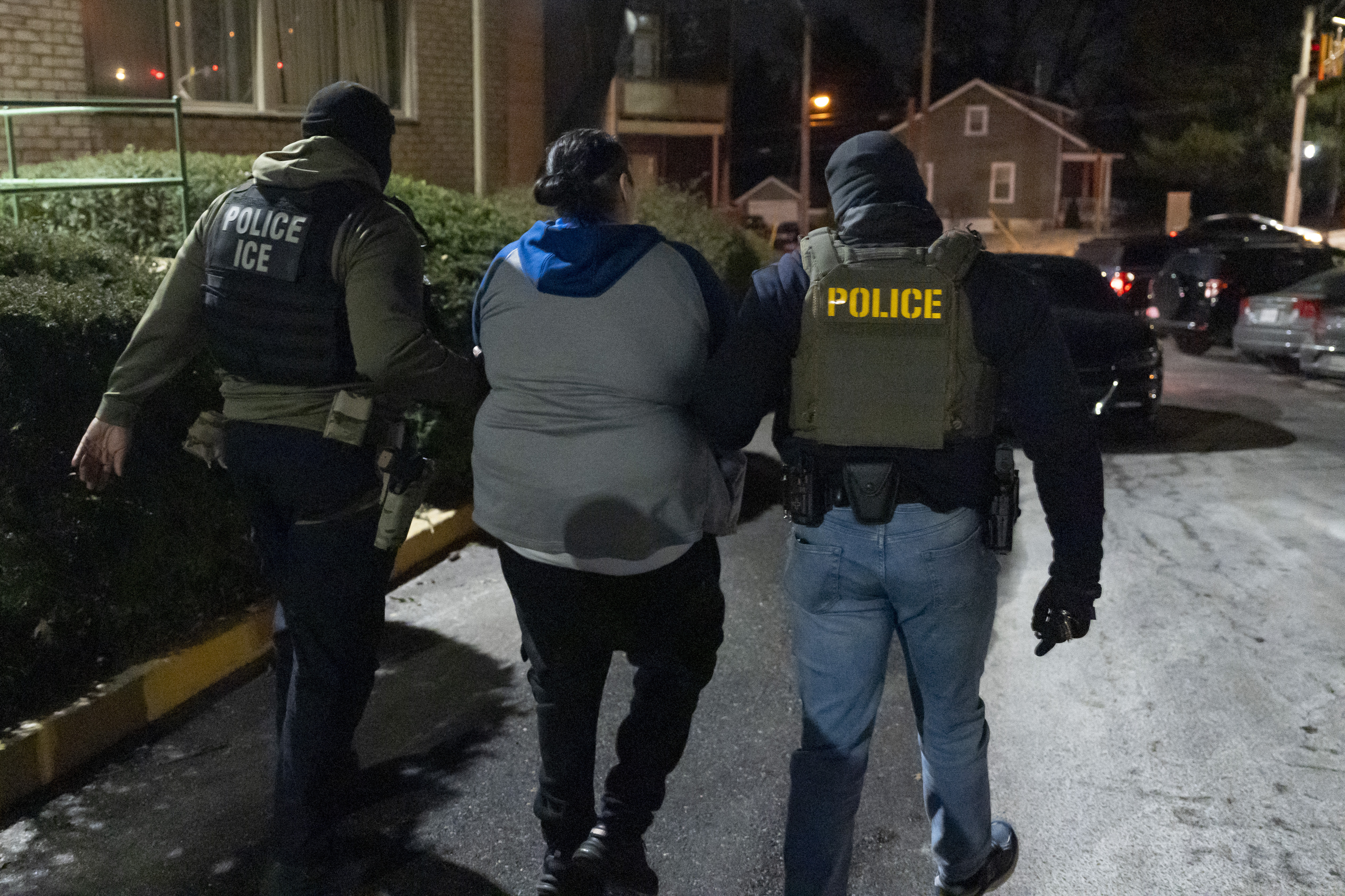 US Immigration and Customs Enforcement officers detain a person.
