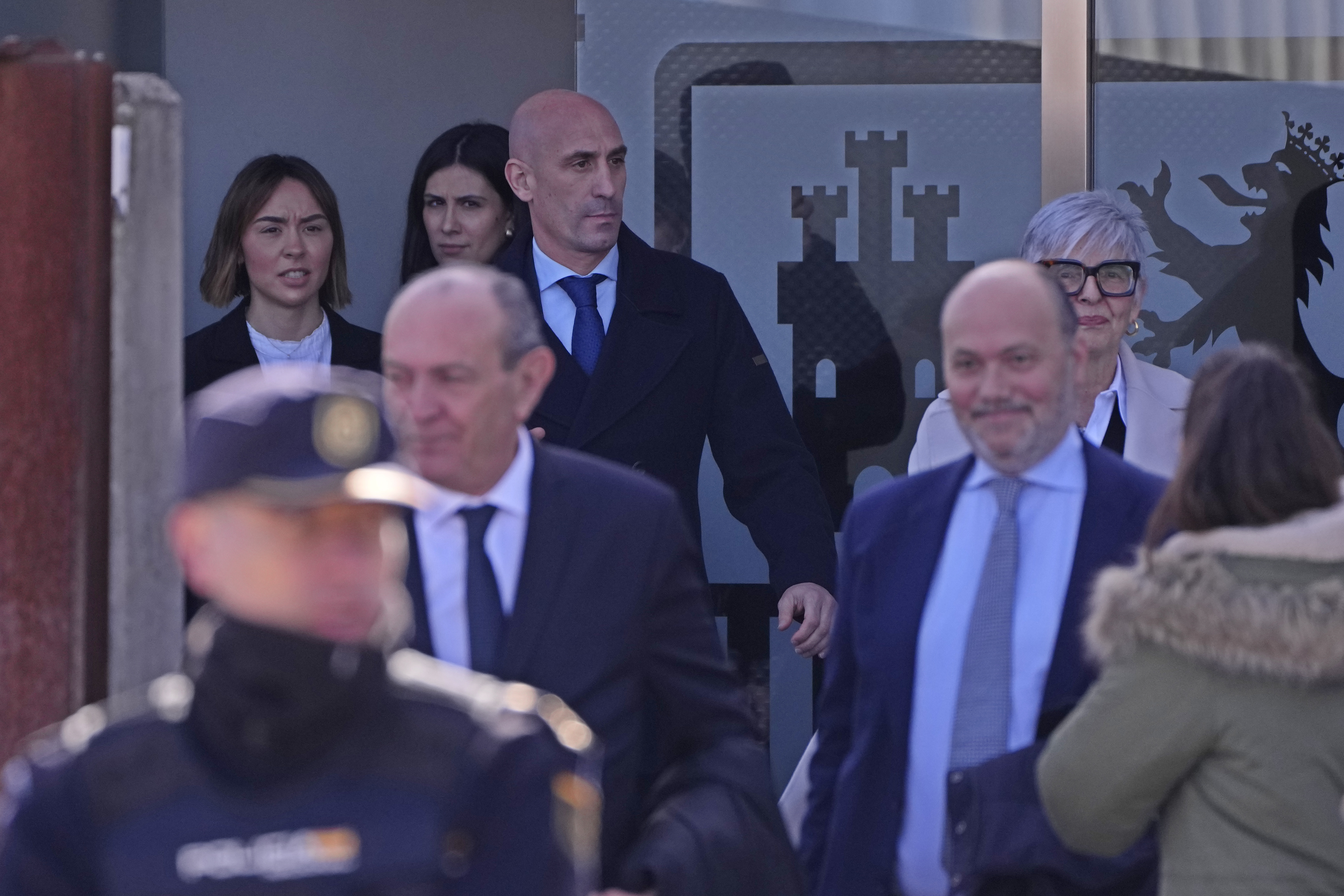 The former president of Spain's soccer federation Luis Rubiales, top,  leaves a court on the outskirts of Madrid, Spain, Monday Feb. 3, 2025 where he is on trial for his unsolicited kiss on forward Jenni Hermoso. (AP Photo/Manu Fernandez)