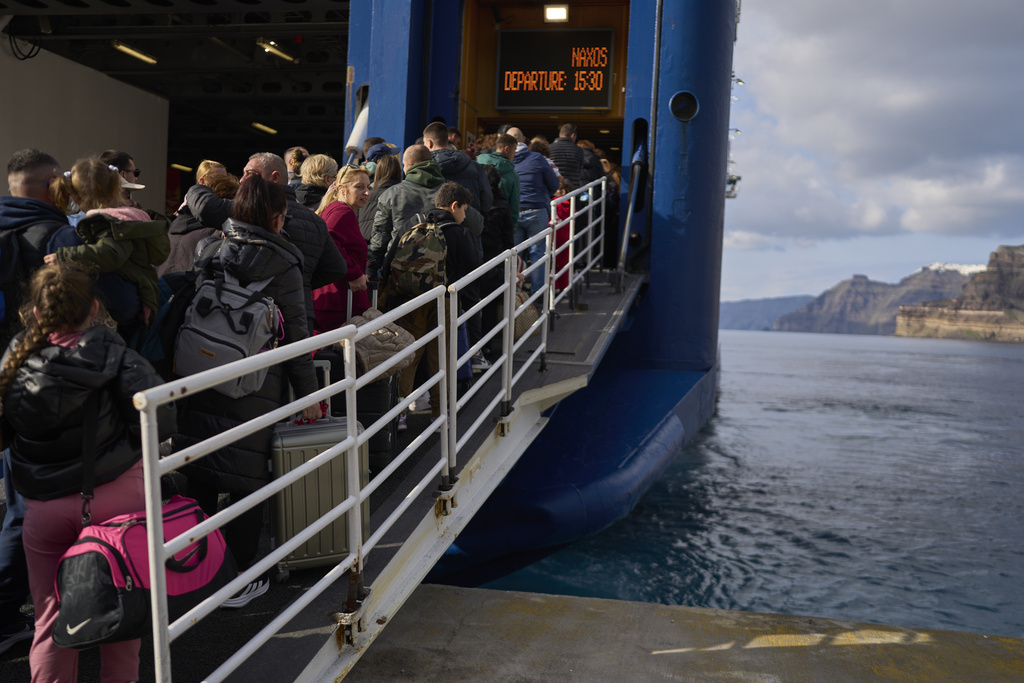 people crowd onto a ferry