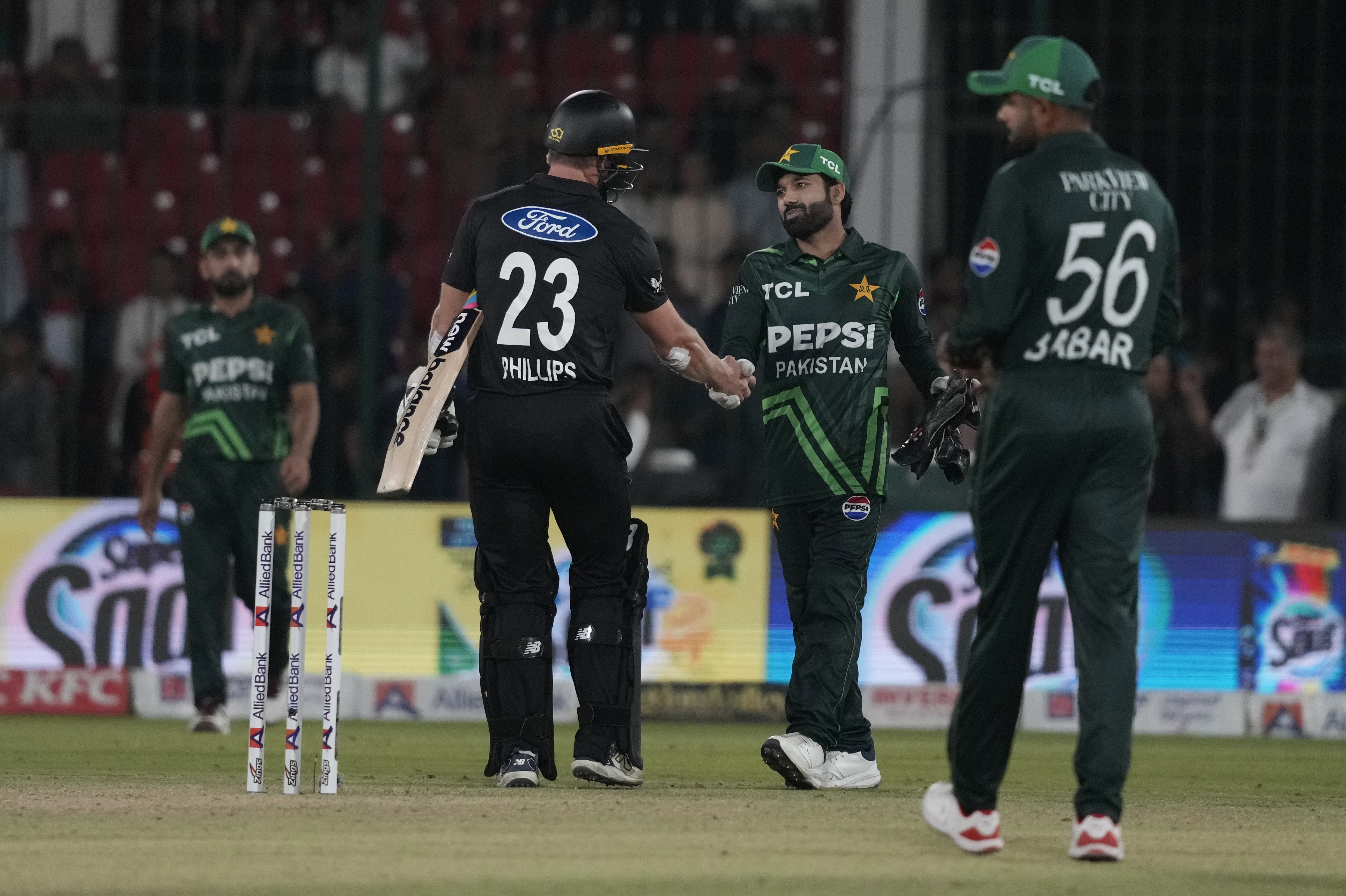 New Zealand's Glenn Phillips, center, shakes hand with Pakistan's Mohammad Rizwan, second right, after winning the tri-series ODI cricket final match against Pakistan, in Karachi, Pakistan, Friday, Feb. 14, 2025. (AP Photo/Fareed Khan)