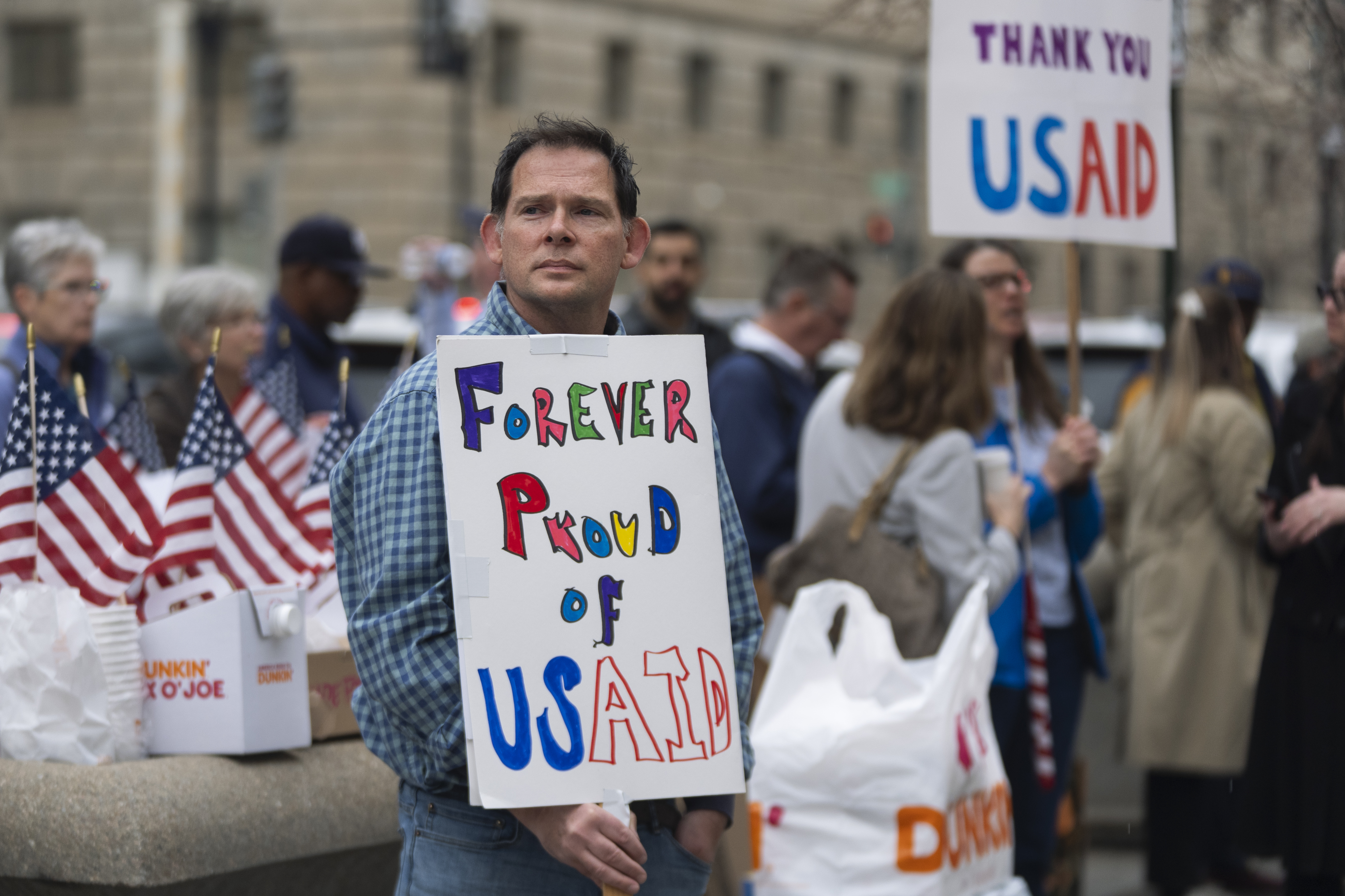 Former United States Agency for International Development (USAID) workers show their support to USAID workers retrieving their personal belongings from USAID's headquarters in Washington, Thursday, Feb. 27, 2025. (AP Photo/Manuel Balce Ceneta)