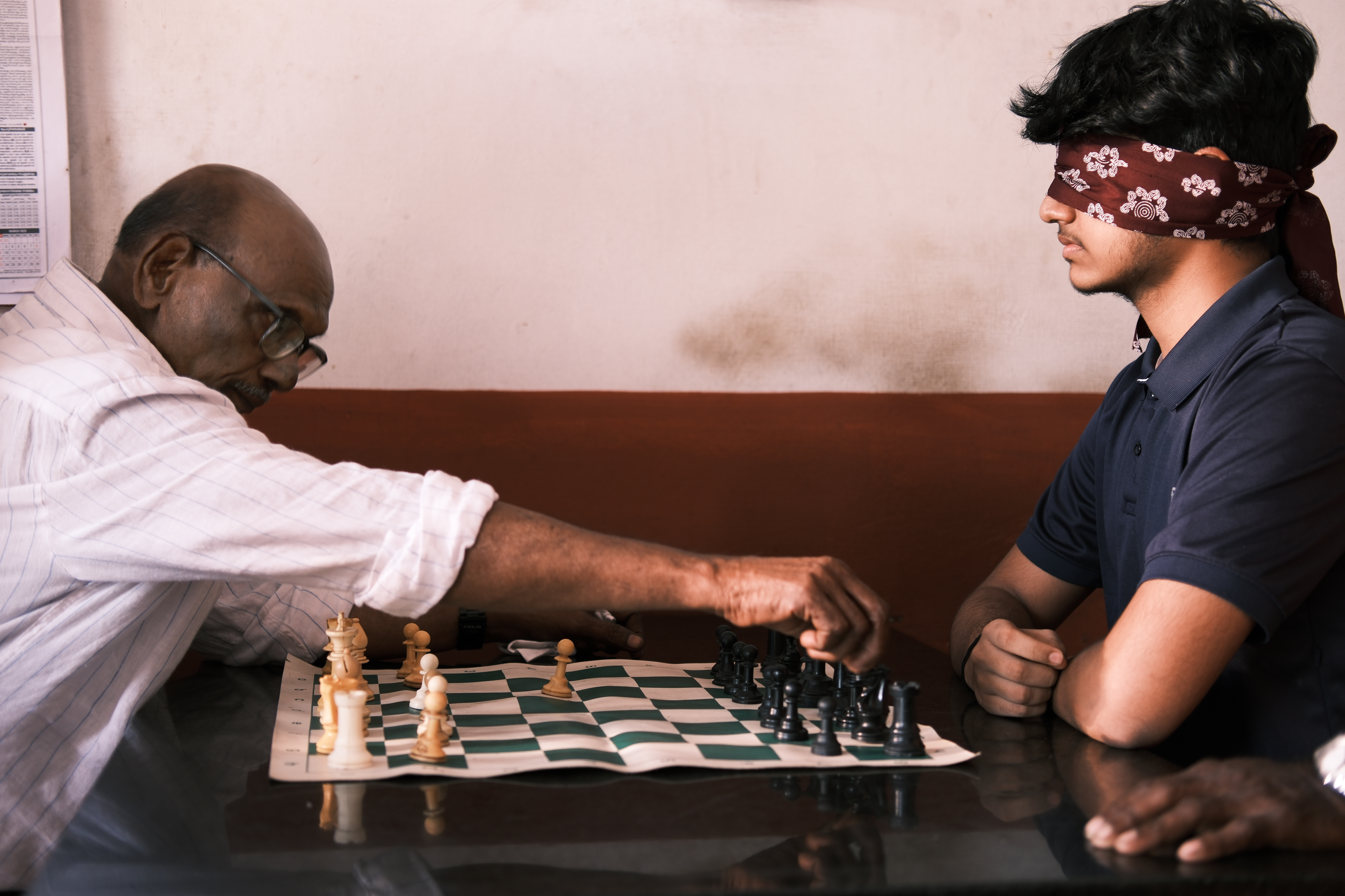 Baby John (left), making his move against a blindfolded Gowrishankar Jayaraj, a rising Indian chess star, in Marottichal [Mirja Vogel/ Al Jazeera] 