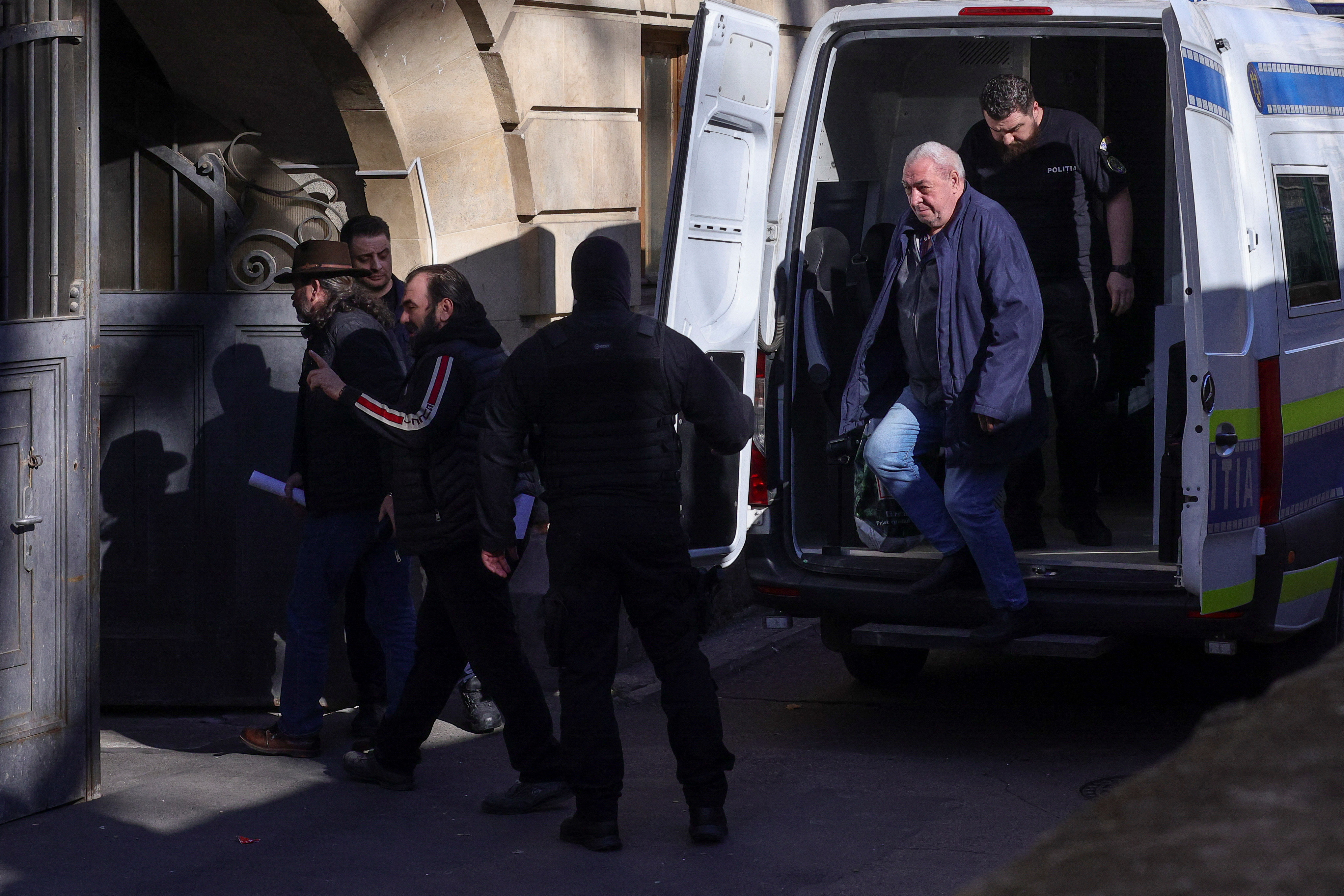 Police officers escort a group of people accused to have been part of an organised crime group and treason, at the Bucharest Court of Appeal, in Bucharest, Romania, March 6, 2025. Inquam Photos/Octav Ganea via REUTERS ATTENTION EDITORS - THIS IMAGE WAS PROVIDED BY A THIRD PARTY. ROMANIA OUT. NO COMMERCIAL OR EDITORIAL SALES IN ROMANIA