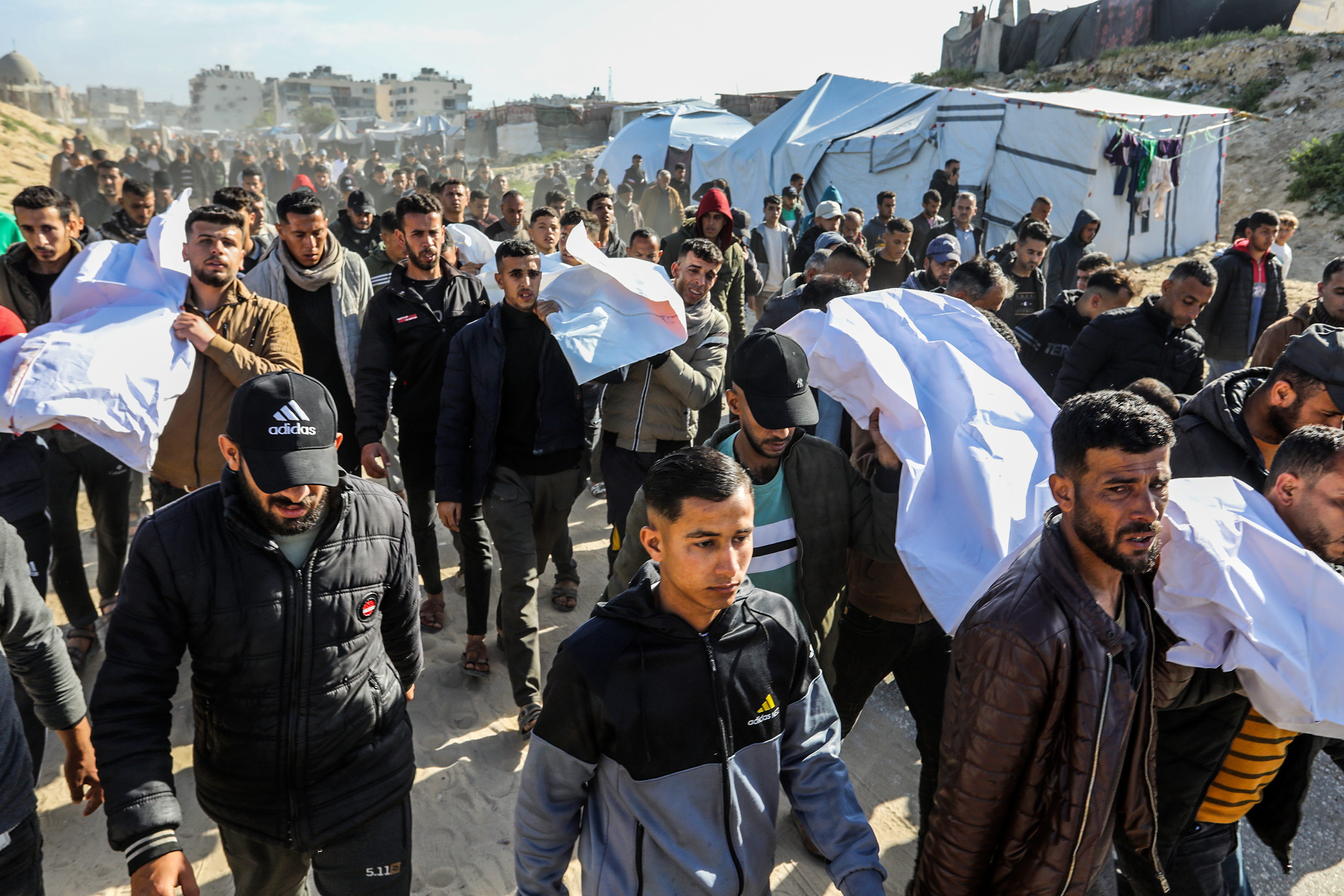 Palestinians visit the grave of a relative after Eid al-Fitr prayers, which marks the end of the holy fasting month of Ramadan, in the Nuseirat camp for Palestinian refugees