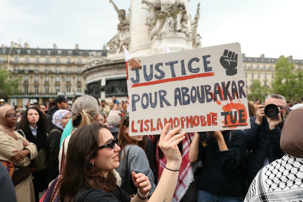 A protester holds a sign reading 'Justice for Aboubakar, Islamophobia kills' during a gathering in tribute to the worshipper killed in a mosque in La Grand-Combe