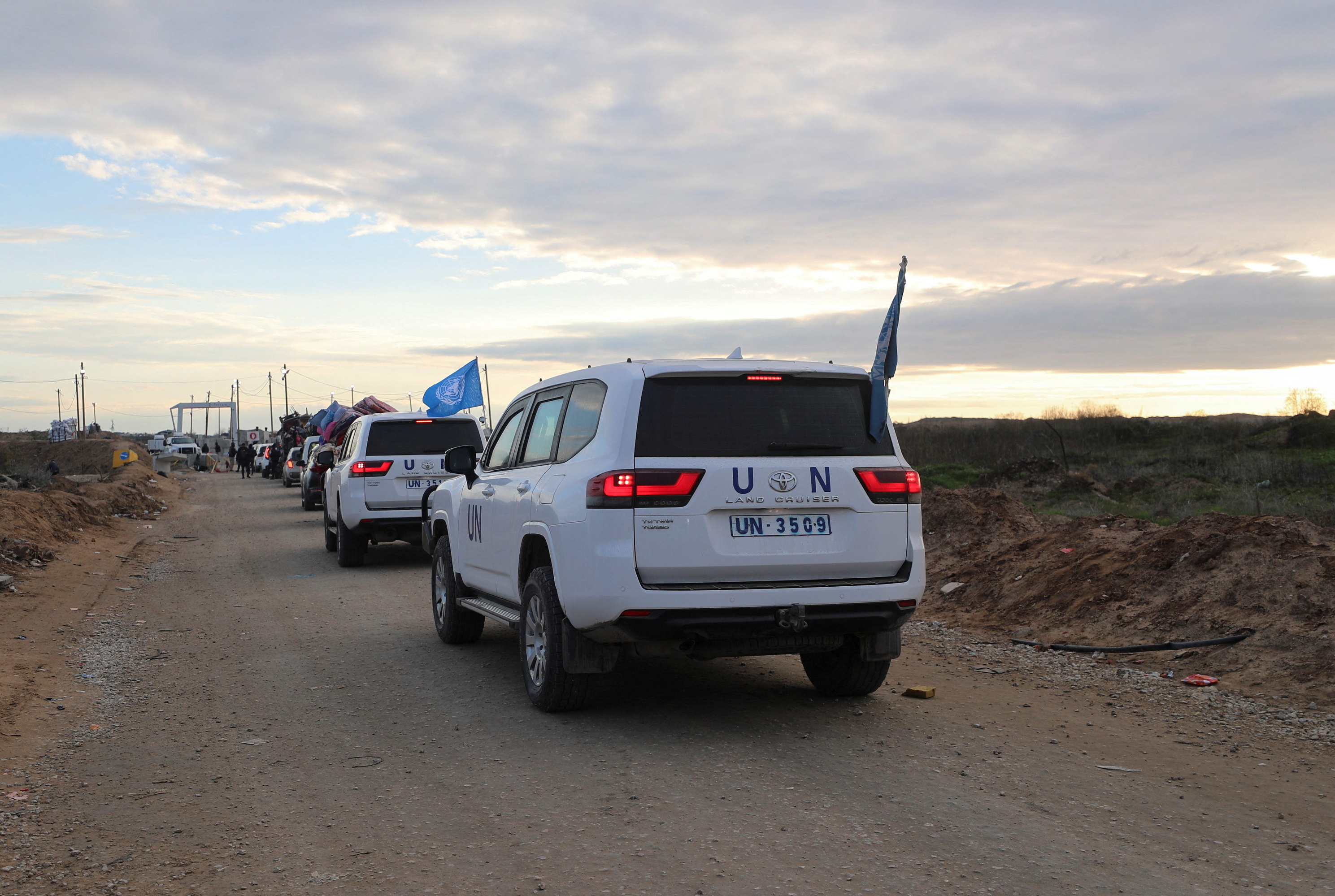 UN vehicles and other cars wait to cross through a checkpoint run by U.S. and Egyptian security contractors after Israeli forces withdrew from the Netzarim Corridor, allowing people to travel in both directions between southern and northern Gaza, amid a ceasefire between Israel and Hamas, near Gaza City, February 9, 2025. REUTERS/Dawoud Abu Alkas