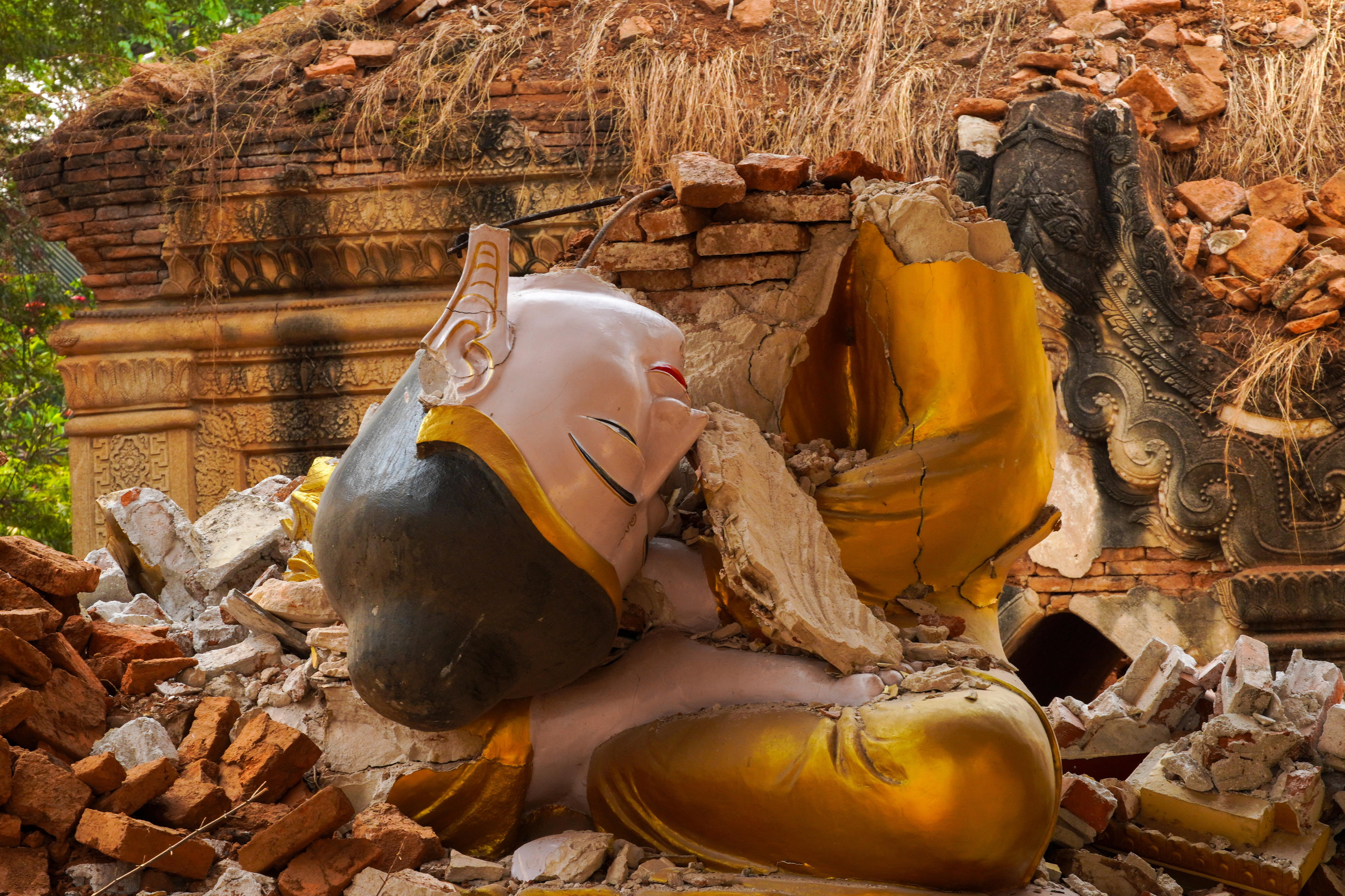 A broken Buddha statue is pictured inside a damaged pagoda following a strong earthquake.
