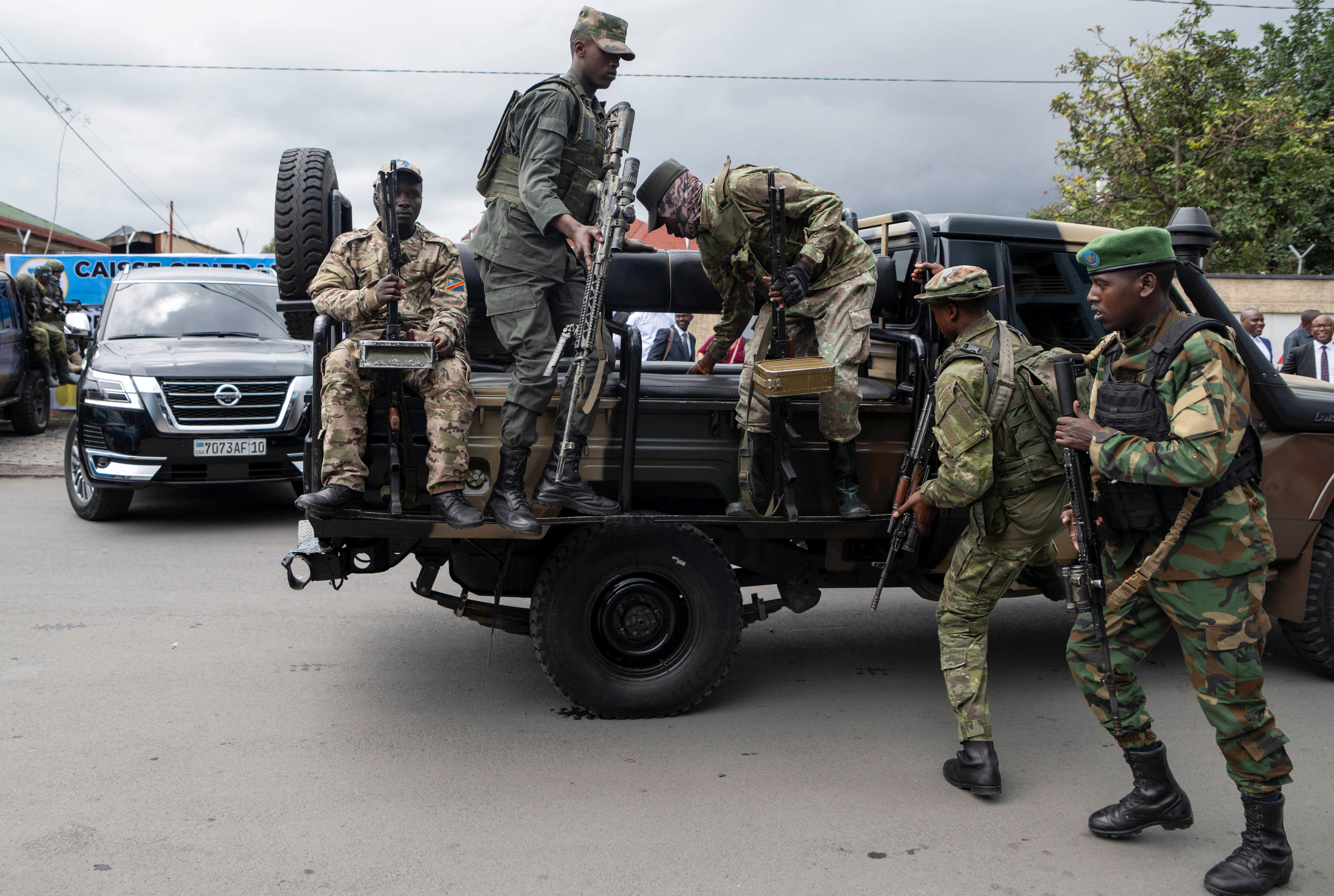 Members of the M23 rebel group mount their vehicles after the opening ceremony of Caisse Generale d'epargne du Congo (CADECO) which will serve as the bank for the city of Goma where all banks have closed since the city was taken by the M23 rebels, in Goma, North Kivu province in the East of the Democratic Republic of Congo, April 7, 2025. REUTERS/Arlette Bashizi