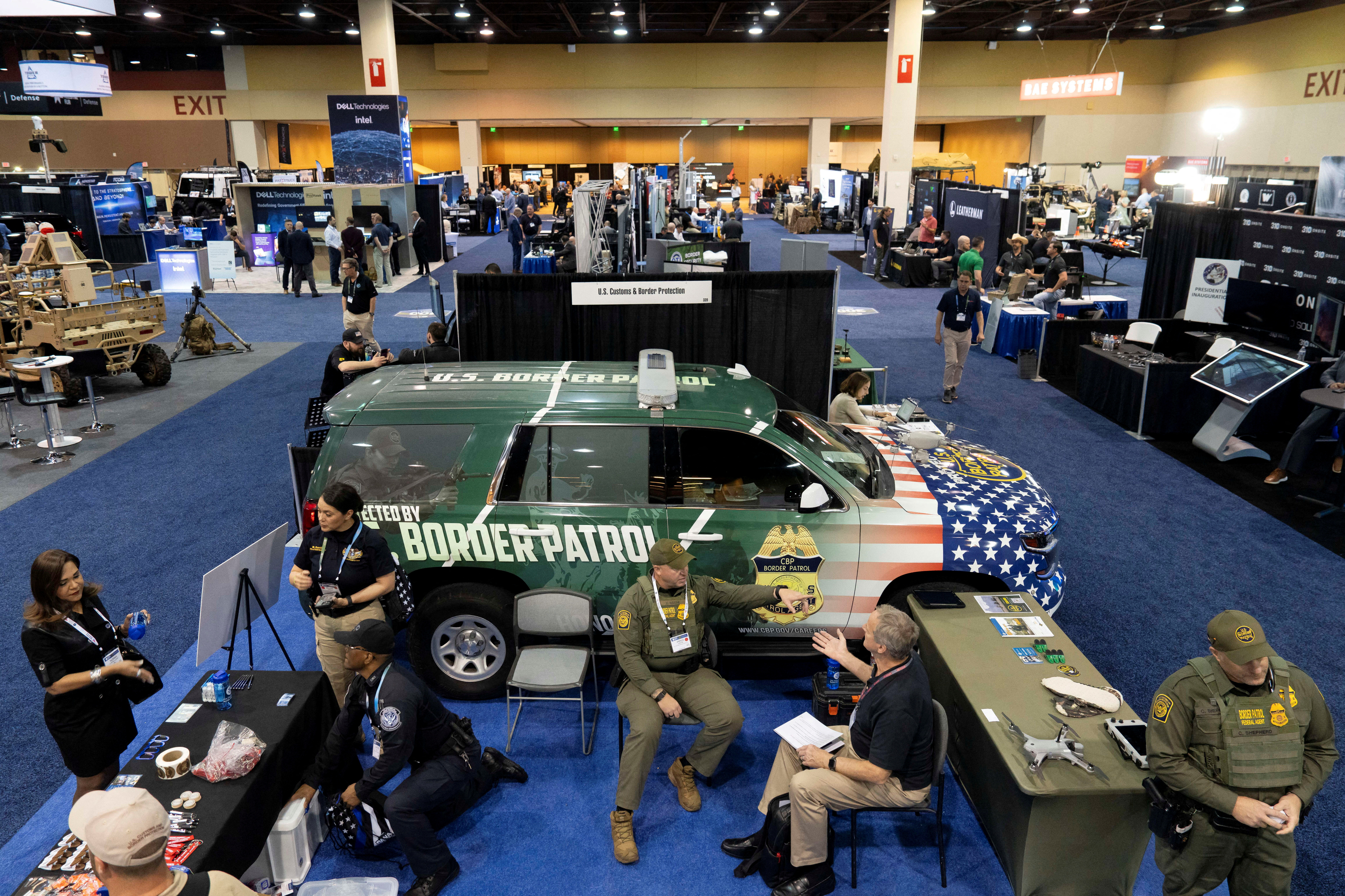 US Customs and Border Protection and Border Patrol agents chat beside a decorated Tahoe during the Border Security Expo at the Phoenix Convention Center in Phoenix, Arizona, US April 9, 2025