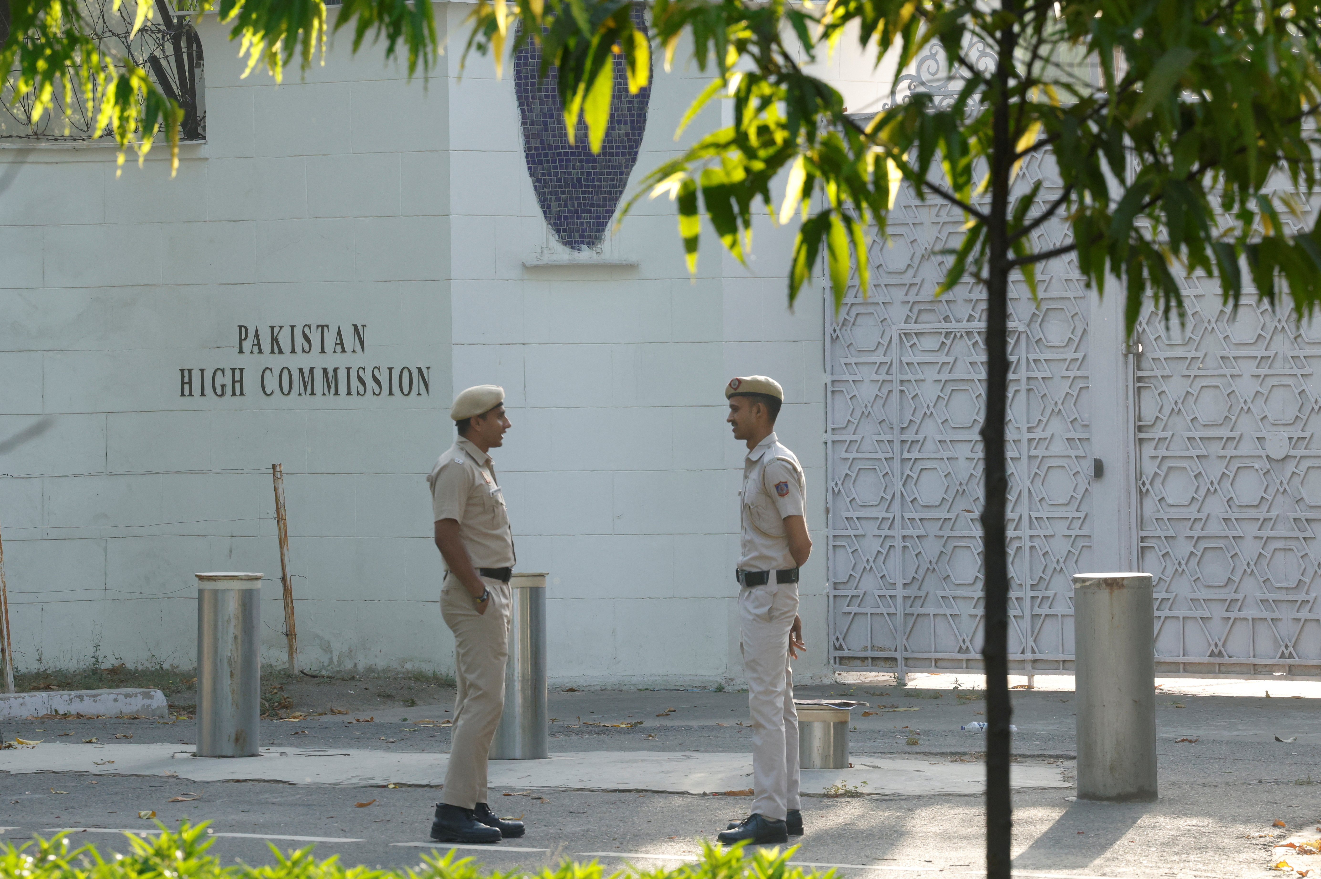 Policemen stand outside the gate of Pakistan High Commission in New Delhi, India