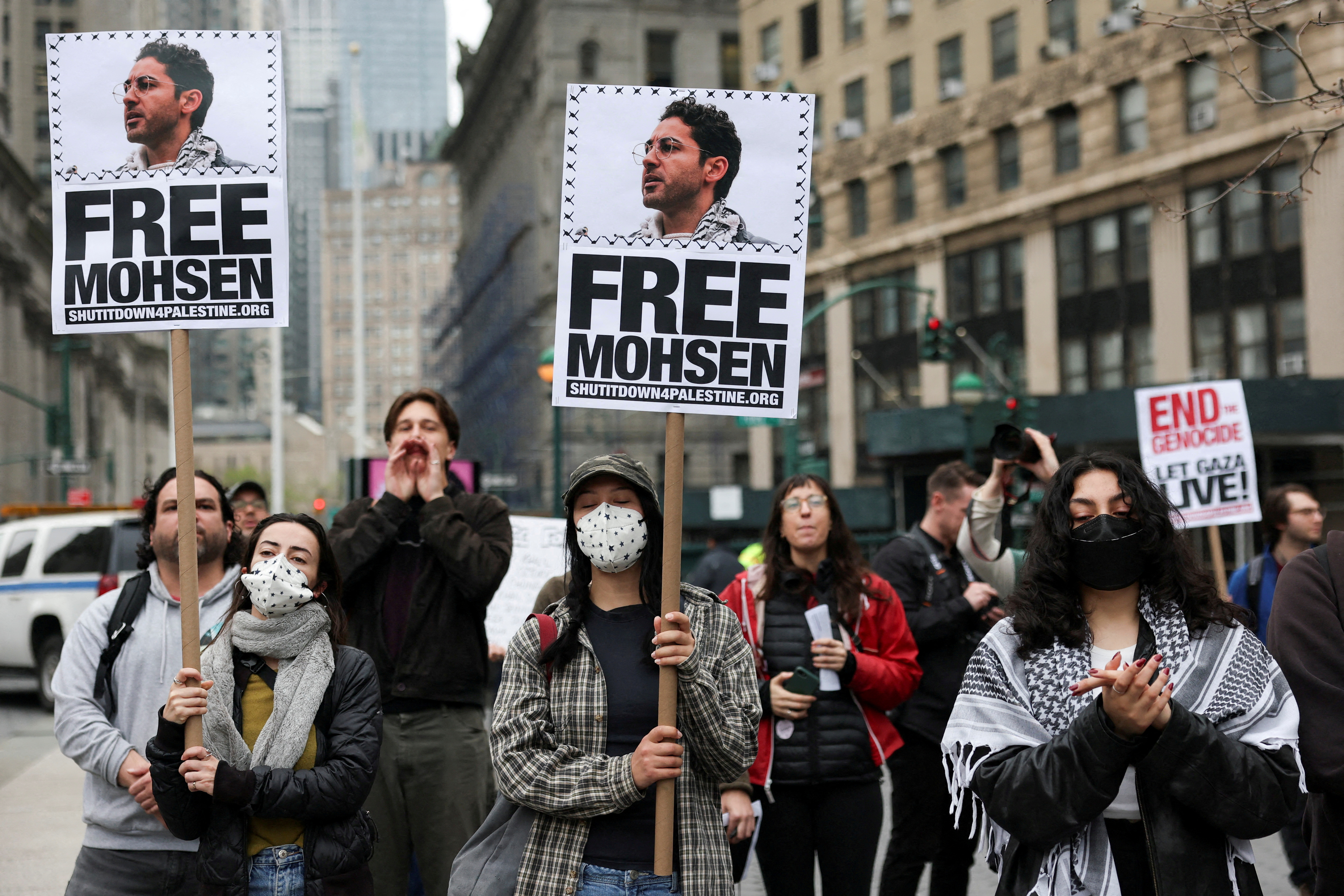 Protesters in New York City streets hold placards to demand the release of Mohsen Mahdawi