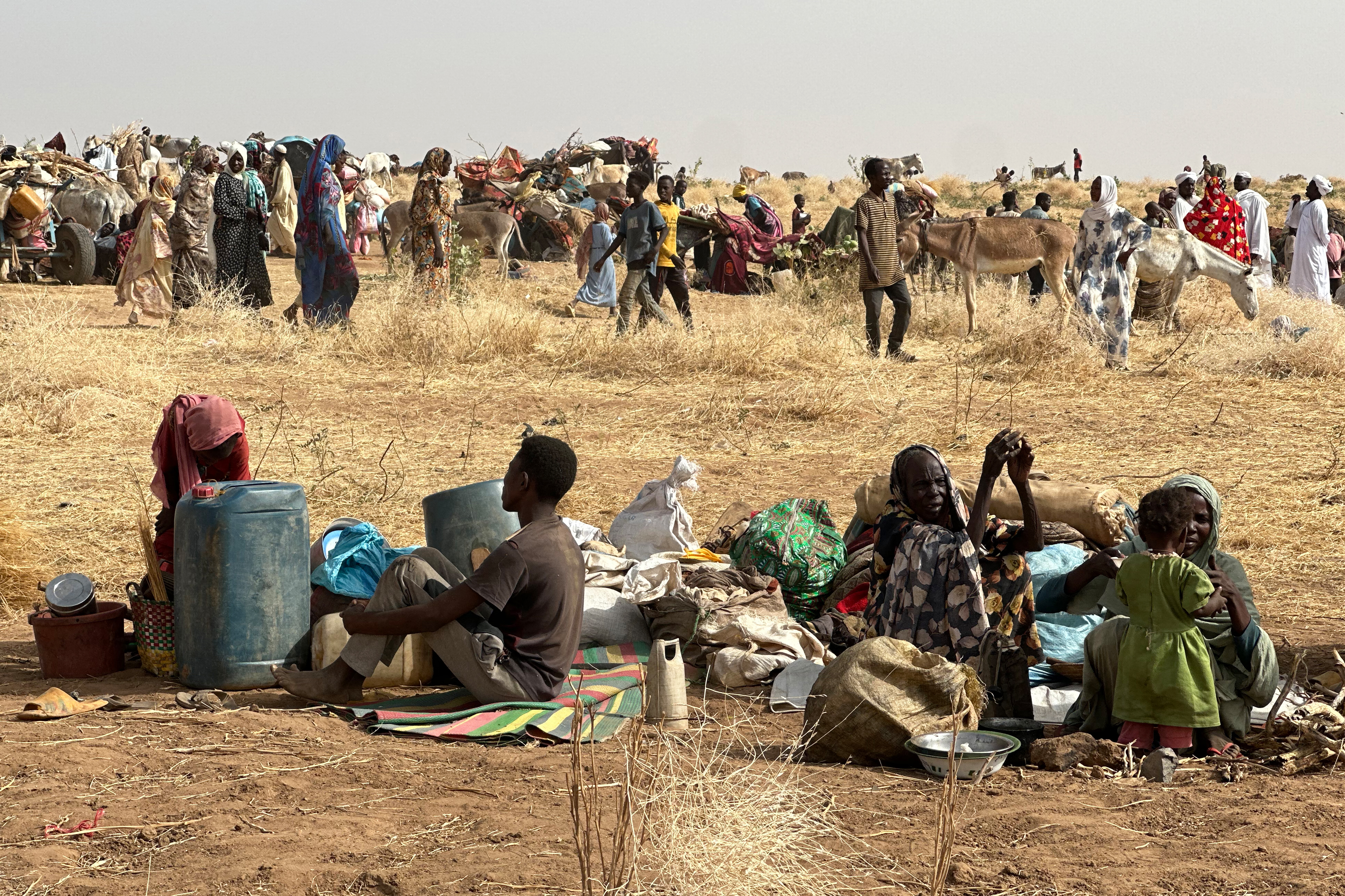 People who fled the Zamzam camp for the internally displaced after it fell under RSF control, rest in a makeshift encampment in an open field near the town of Tawila in war-torn Sudan's western Darfur region on April 13, 2025. Sudan's paramilitary Rapid Support Forces (RSF) announced on April 13 that it had taken control of the famine-hit Zamzam camp, home to over 500,000 refugees according to the United Nations, after two days of heavy shelling and gunfire, amid its ongoing war with the country's army and affiliated forces. (Photo by AFP)