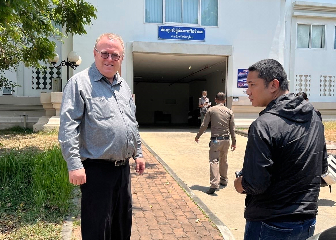 Paul Chambers stands outside a police station.