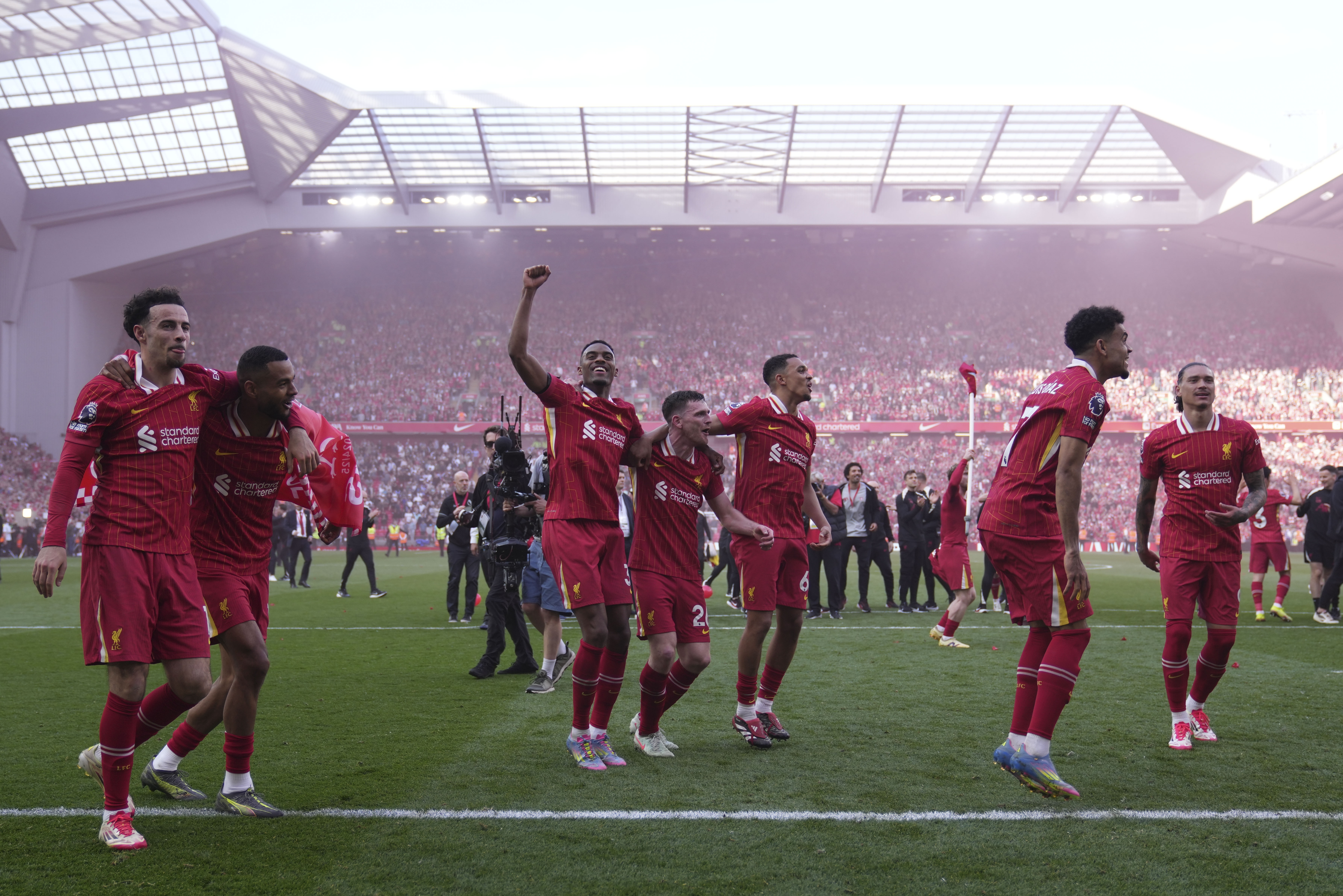 Liverpool players celebrate after winning the English Premier League soccer match between Liverpool and Tottenham Hotspur and clinching the Premier League title at Anfield in Liverpool, England, Sunday, April 27, 2025. (AP Photo/Jon Super)