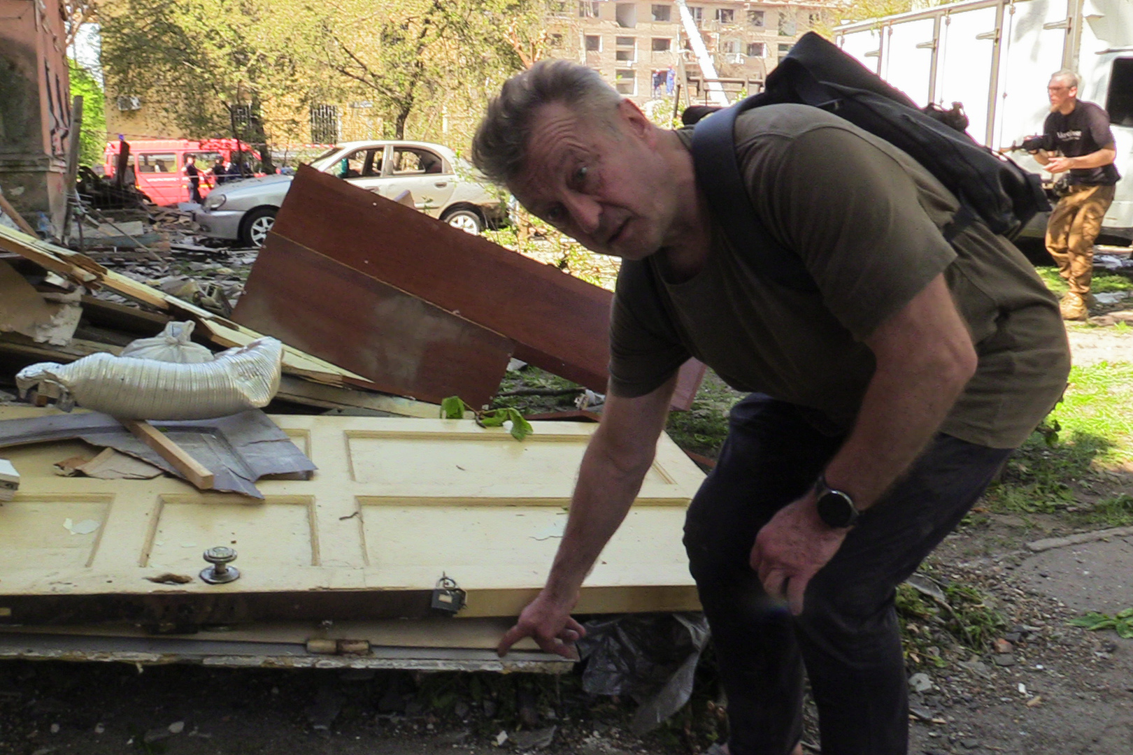 Serhiy Parkhomenko shows the steel door that flew across his living room after the Thursday morning missile strike