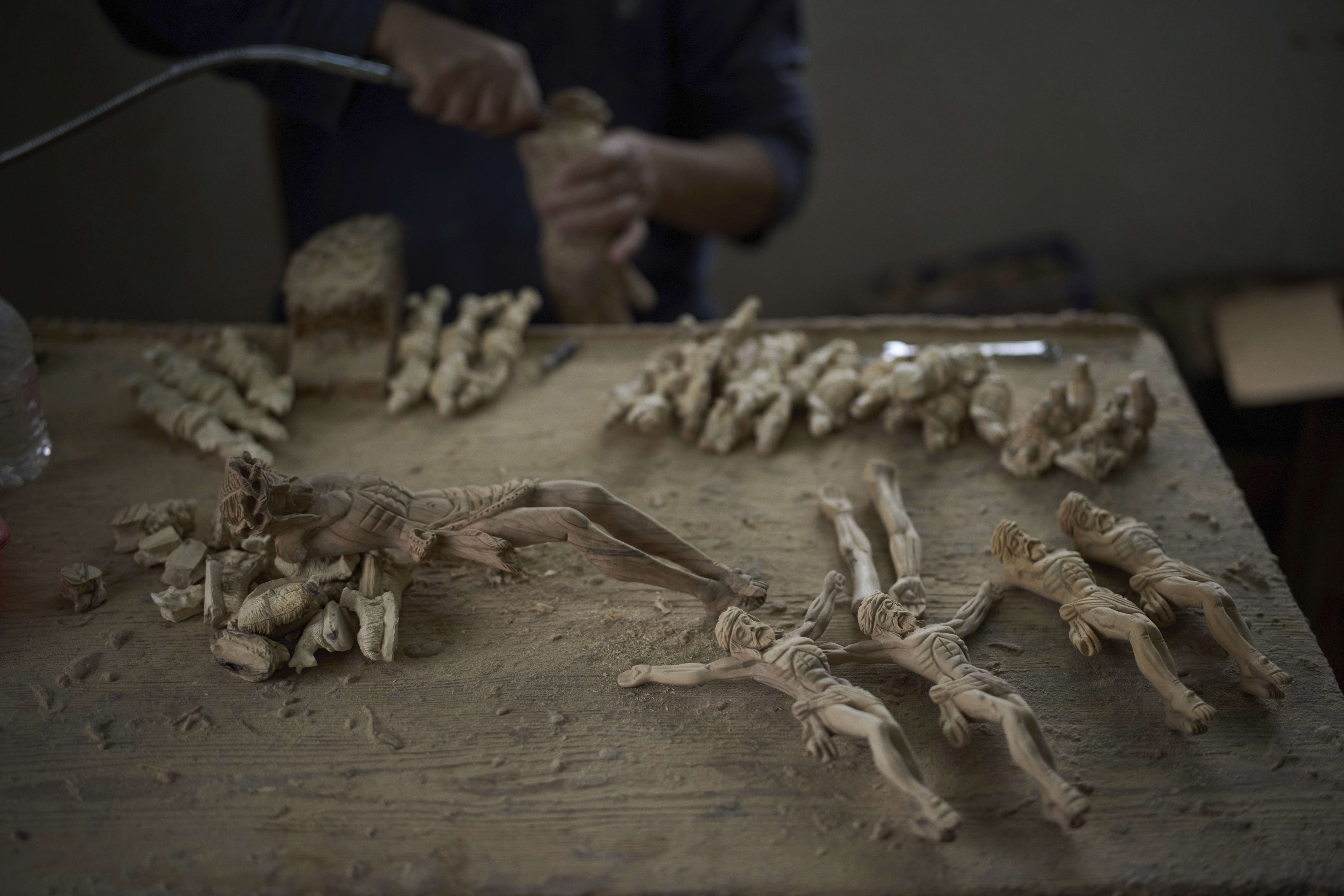A Palestinian woodcarver works on an olive-wood sculpture of Jesus Christ at the Zacharia workshop prior to Holy Week celebrations in the West Bank city of Bethlehem, Tuesday on April 8, 2025. (AP Photo/Leo Correa)