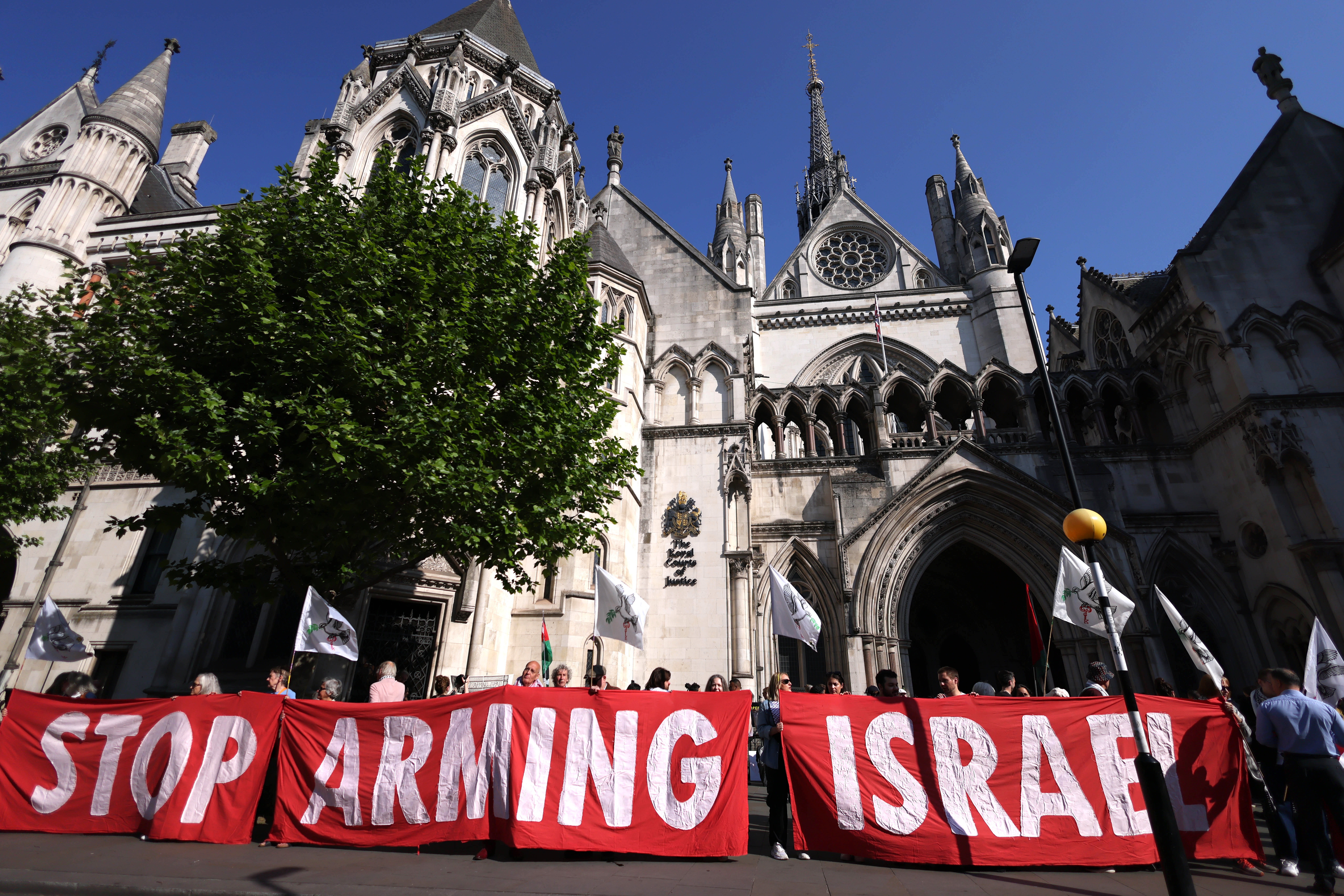 epa12095660 Protesters display banners as they demonstrate against selling arms to Israel at the Royal Courts of Justice in London, Britain, 13 May 2025. A four-day judicial review brought by Palestinian rights group Al-Haq and the Global Legal Action Network (GLAN) starts in the High Court on 13 May, with human rights' groups and lawyers arguing that UK's sale of arms to Israel is unlawful. EPA-EFE/NEIL HALL
