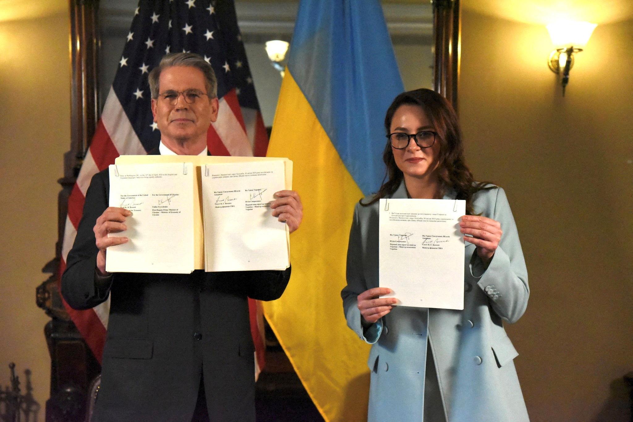 US Treasury Secretary Scott Bessent and Ukrainian Vice Prime Minister Yulia Svyrydenko pose after signing a deal.