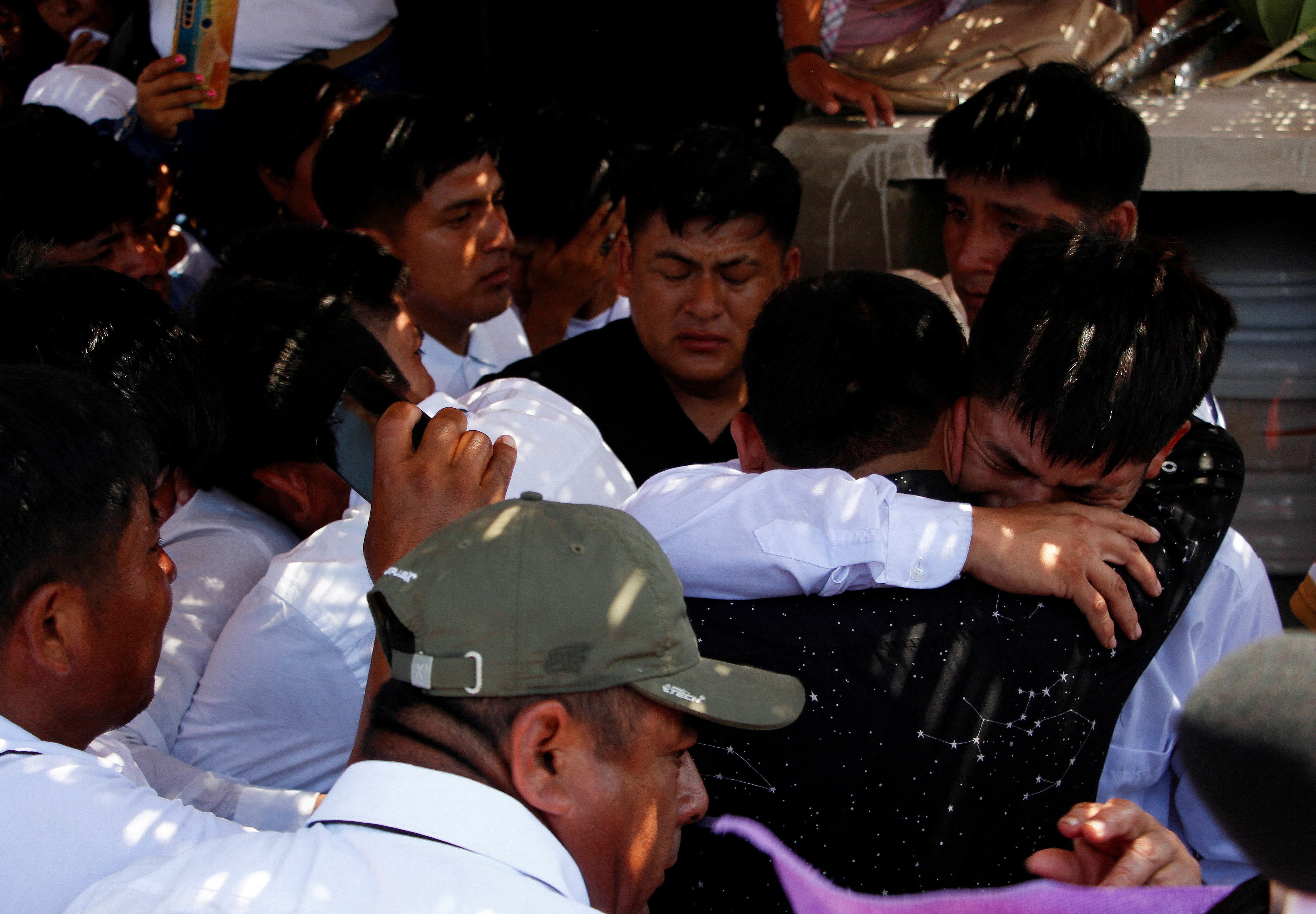 Friends and family members react during the funeral of mine worker Darwin Cobenas who along with fellow workers had been kidnapped by illegal miners last month and killed, in Piura, Peru