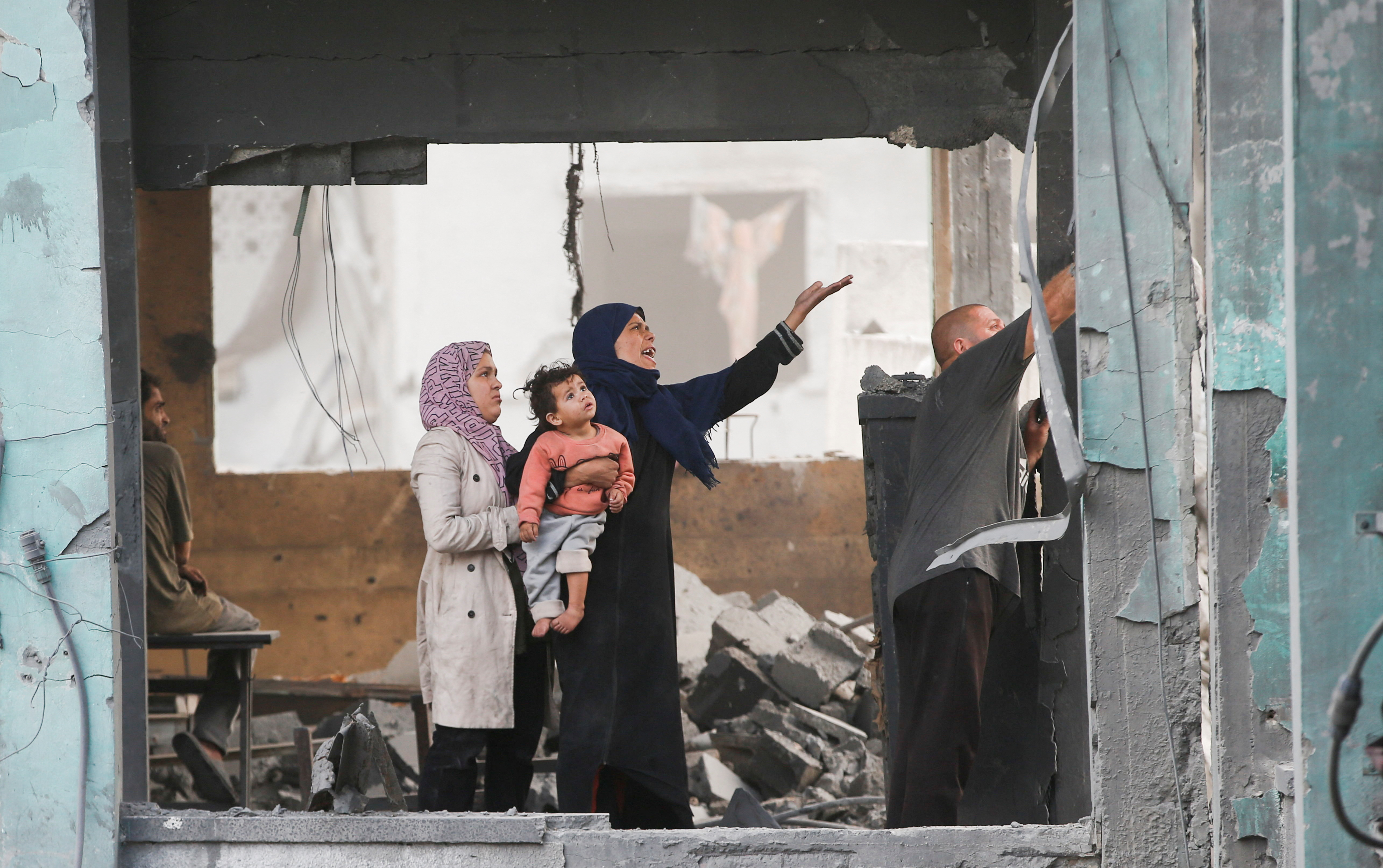 Palestinians react as they inspect the damage at a school sheltering displaced people, following an Israeli strike, in Jabalia refugee camp, in the northern Gaza Strip, May 12, 2025. REUTERS/Mahmoud Issa