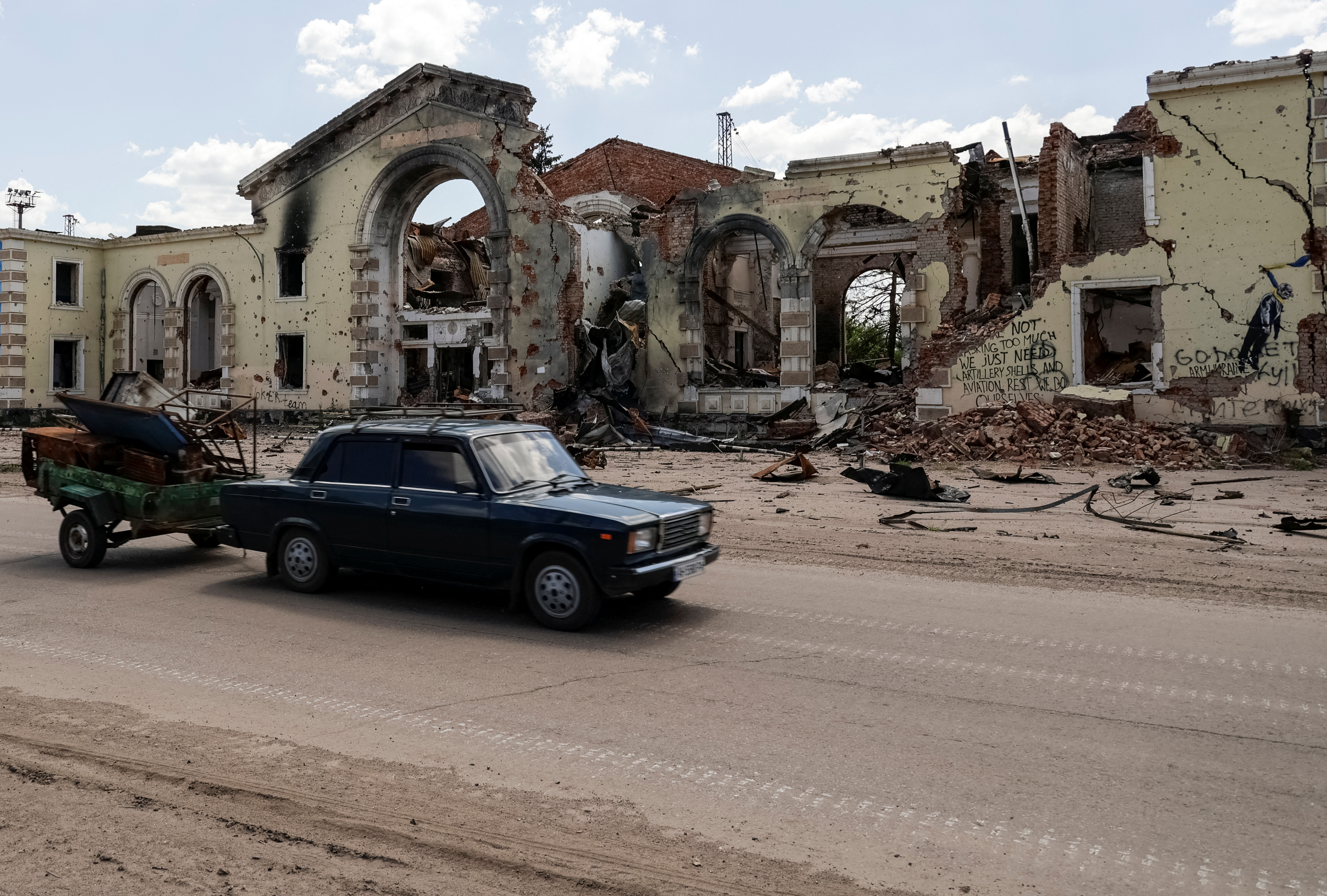 Residents ride a car, near a railway station damaged by Russian military strikes, amid Russia's attack on Ukraine, in the frontline town of Kostyantynivka, Donetsk region, Ukraine May 23, 2025. REUTERS/Sofiia Gatilova