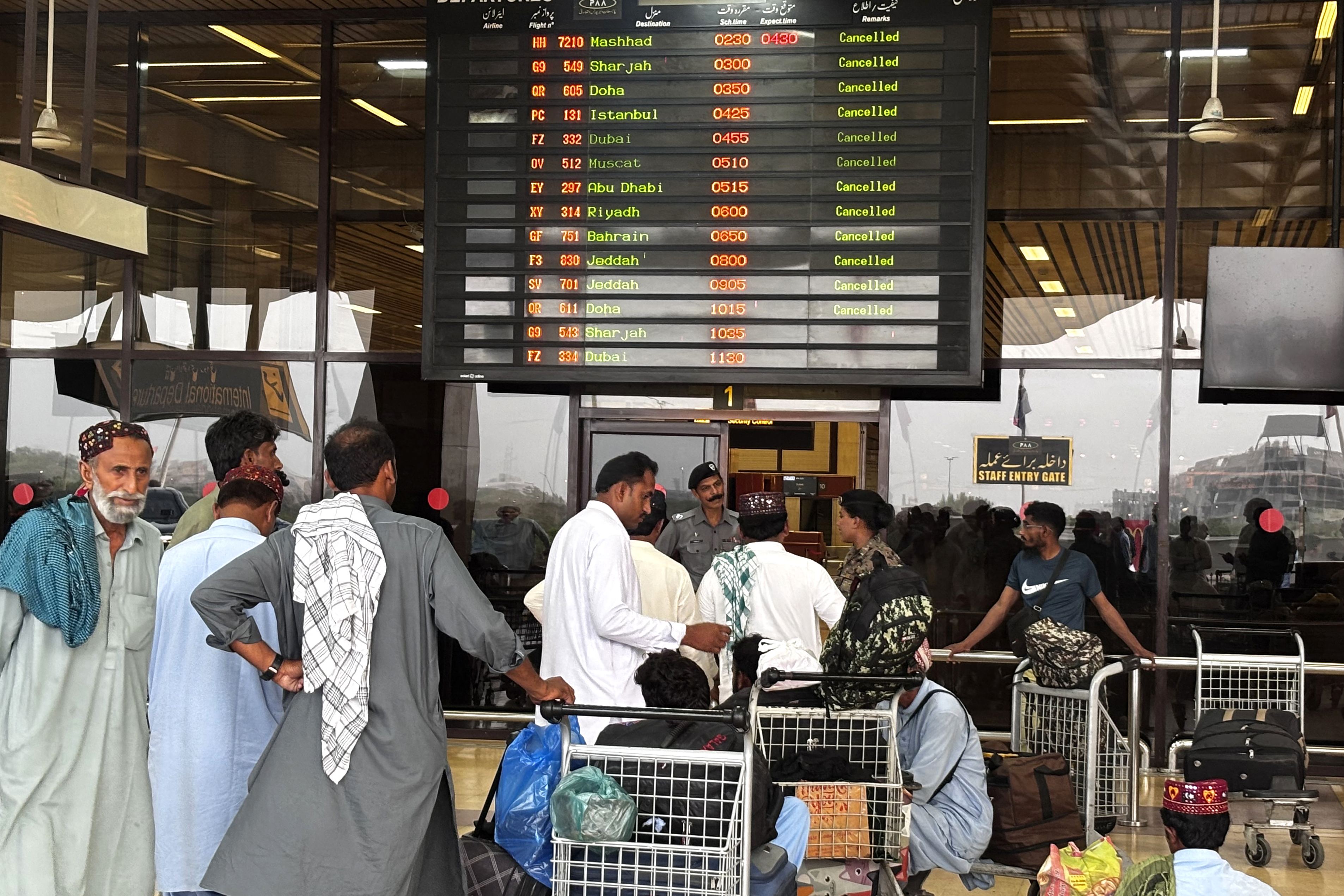 Passengers wait at Jinnah International Airport.