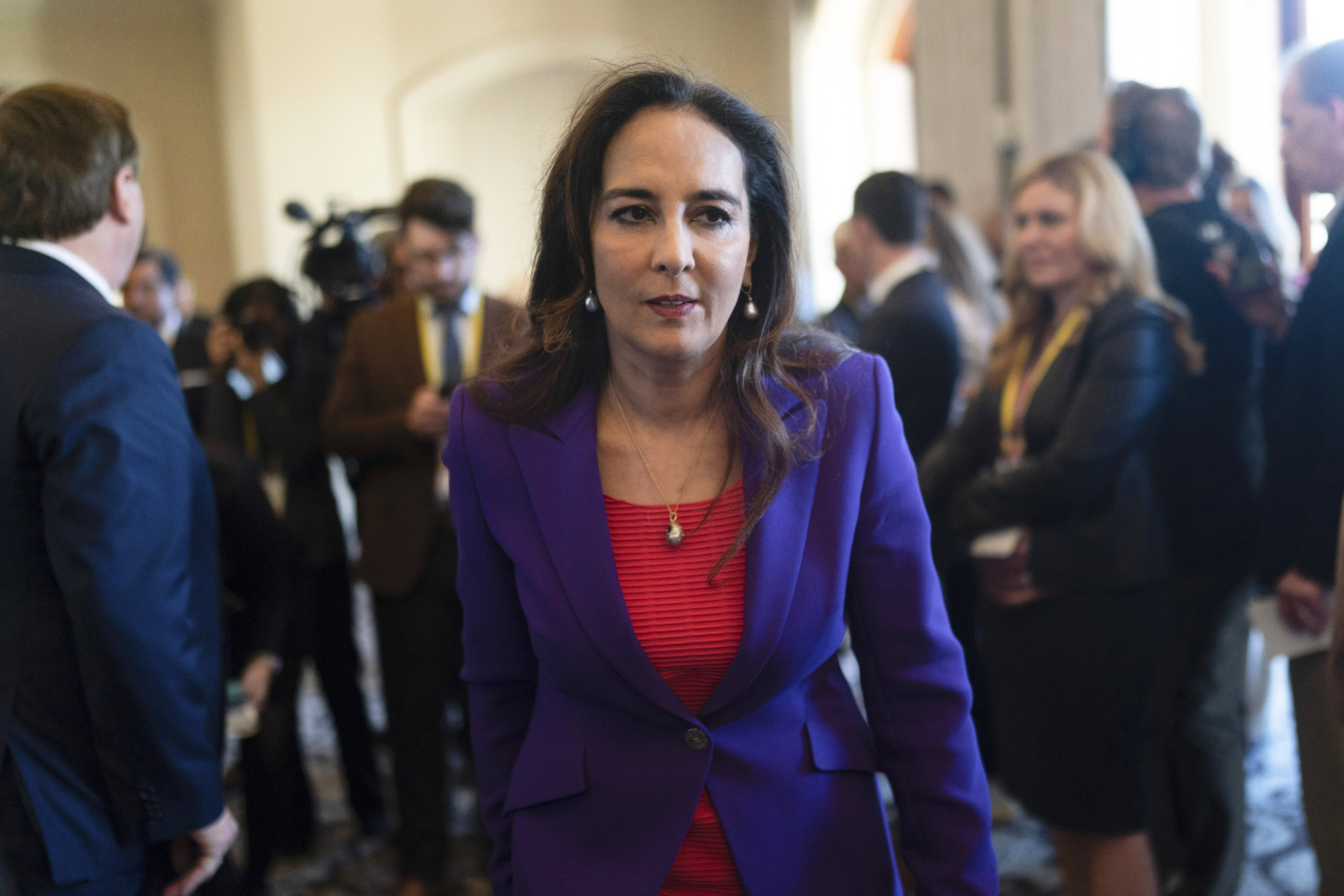 Harmeet Dhillon walks down a hallway