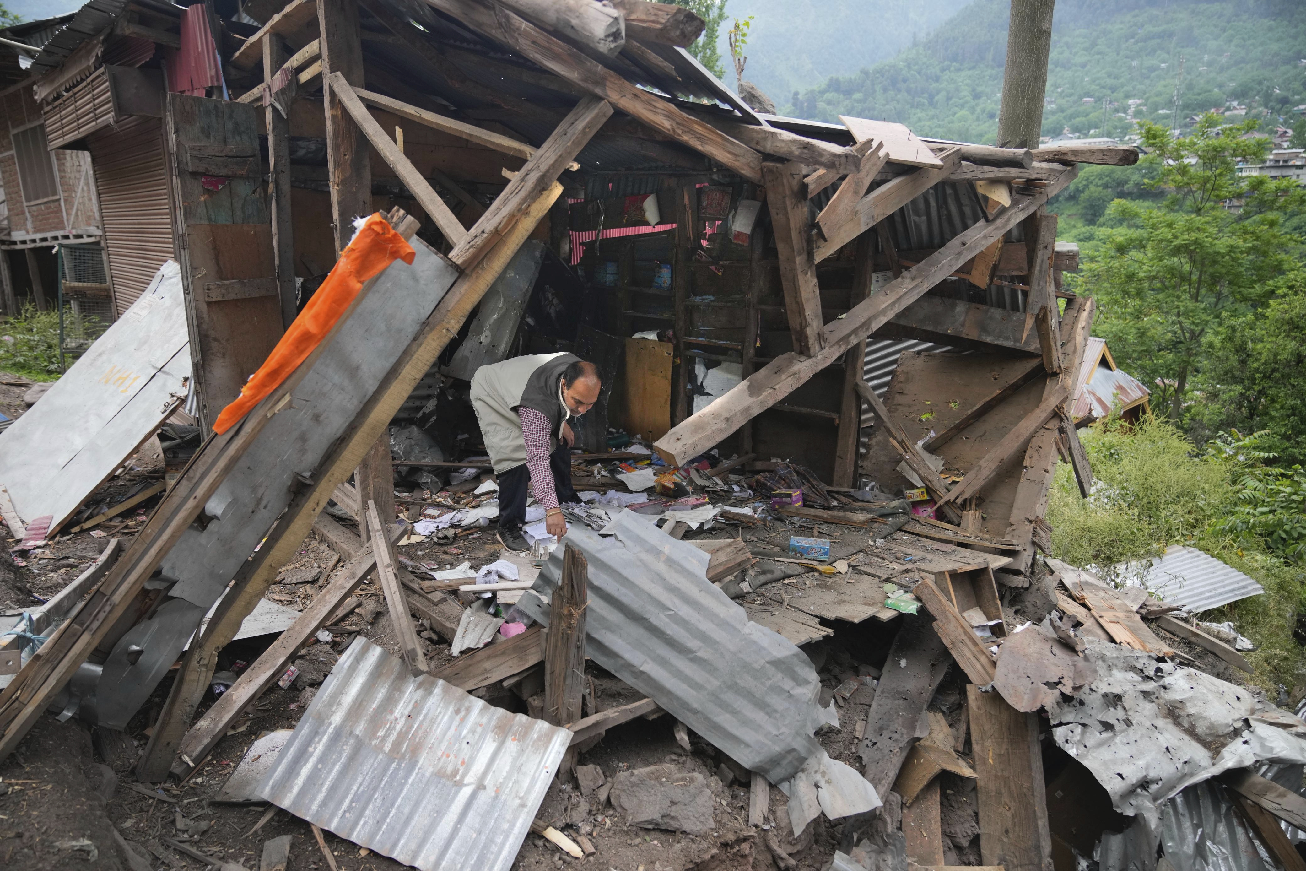A person inspects his damaged shop following overnight shelling from Pakistan at Gingal village in Uri district, Indian controlled Kashmir, Friday, May 9, 2025.