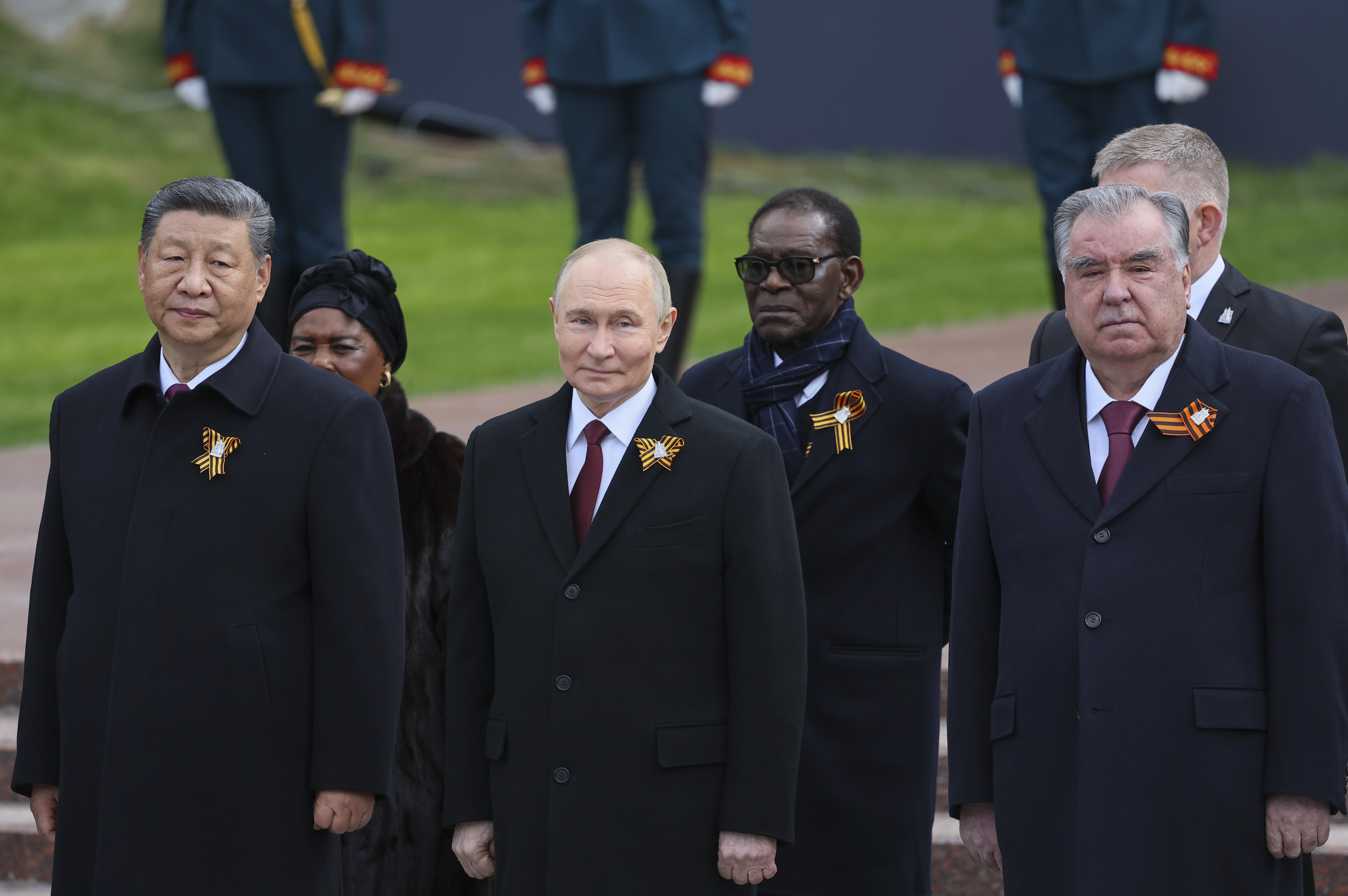 Chinese President Xi Jinping, left, Russian President Vladimir Putin, centre, Tajikistan's President Emomali Rahmon, right, and President of the Republic of Congo Denis Sassou Nguesso, centre right, attend a wreath laying ceremony.